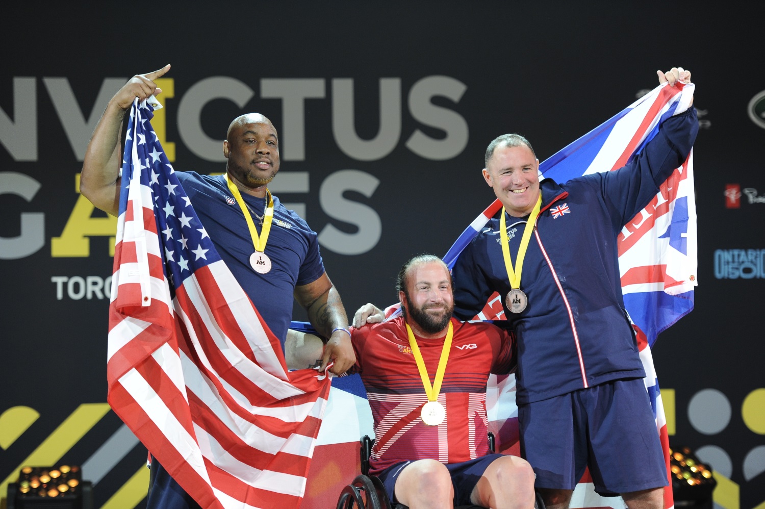 The three men's powerlifting competition finalists pose for a photo after a medal ceremony during the 2017 Invictus Games at the Mattamy Athletics Centre in Toronto, Canada, on Sept. 26, 2017. Retired U.S. Air Force Staff Sgt. Nathaniel Bias, left, won silver. The Invictus Games are the sole international adaptive sporting event for injured active-duty and veteran service members. (Staff Sgt. Jannelle McRae/Air Force)