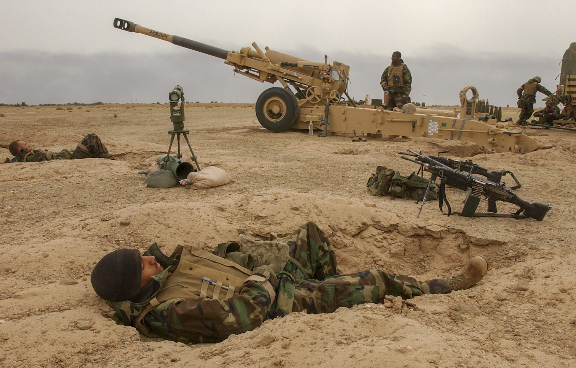 03/22/2003 Images shot in southern Iraq Photo by Jud McCrehin/Marine Corps Times Lance Cpl. Guilbert Alce, 23, with battery M, 3rd Battalion, 11th Marine Regiment takes a nap in his sleeping hole near the 155mm Howitzer he works as a powder man on in an artillery position in southern Iraq.