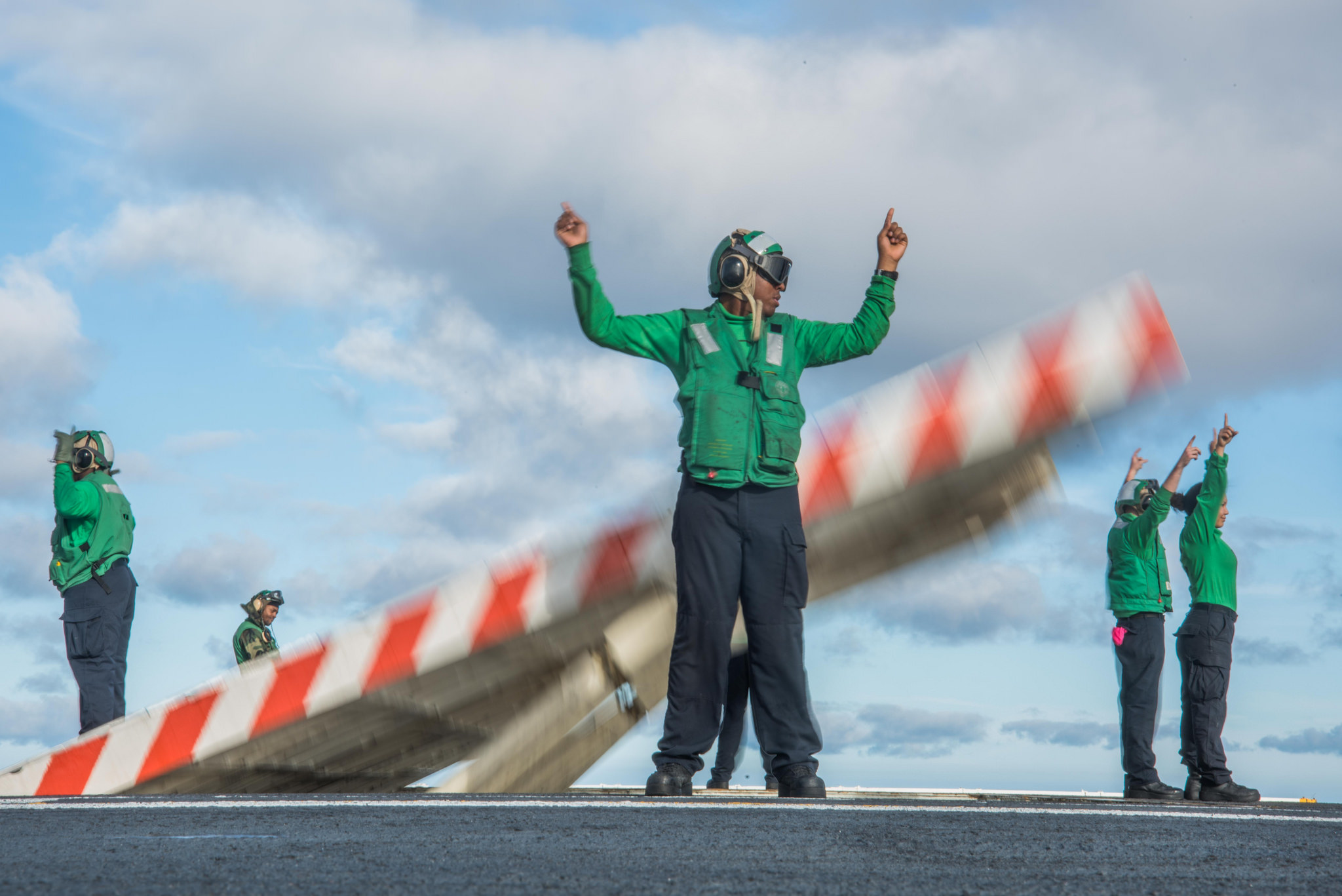 Sailors assigned to USS John C. Stennis (CVN 74) erect a jet blast deflector on the ship's flight deck on Nov. 9, 2017, in the Pacific Ocean. (MC3 William Ford/Navy)