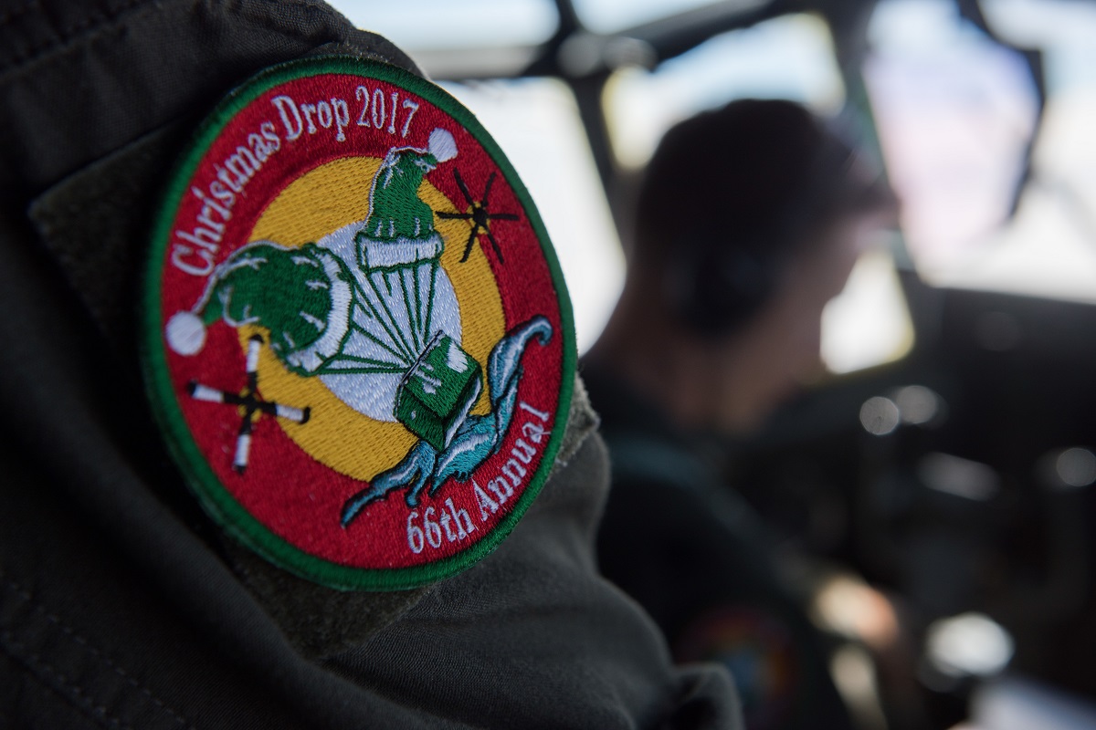 A pilot assigned to the 36th Airlift Squadron wears an Operation Christmas Drop 2017 patch, Dec. 14, 2017, at Andersen Air Force Base, Guam. OCD is the longest running Department of Defense humanitarian airlift training operation and will provide nearly 25 tons of critical supplies to 56 Micronesian islands this year impacting about 20,000 people. (Airman 1st Class Juan Torres Chardon/Air Force)