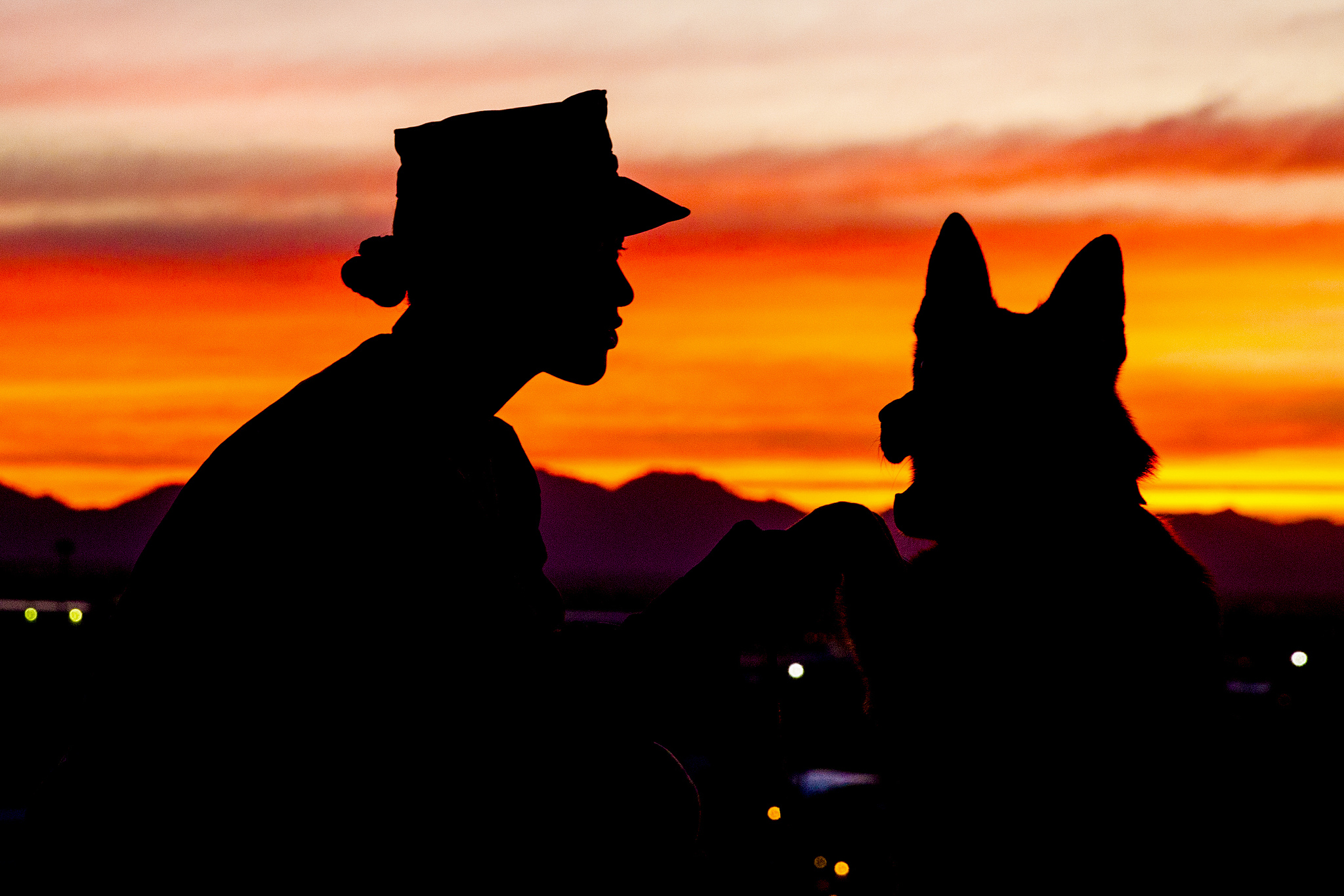 Dog handler Sgt. Jenna L. Cauble poses for a photo with her military working dog, Ken, on Marine Corps Air Station Yuma, Ariz., on Jan. 18, 2019. (Sgt. Allison Lotz/Marine Corps)