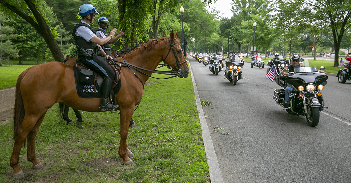 Park Police officers wave to riders as they pass them during Rolling Thunder XXXI First Amendment Demonstration Run along Independence Ave. in Washington, DC on Sunday May 27, 2018. Motorcycle riders from across the nation, rode a designated route through the Mall area of Washington, D.C. The event is an actual demonstration/protest to bring awareness and accountability for POWs and MIAs left behind.(Alan Lessig/Staff)