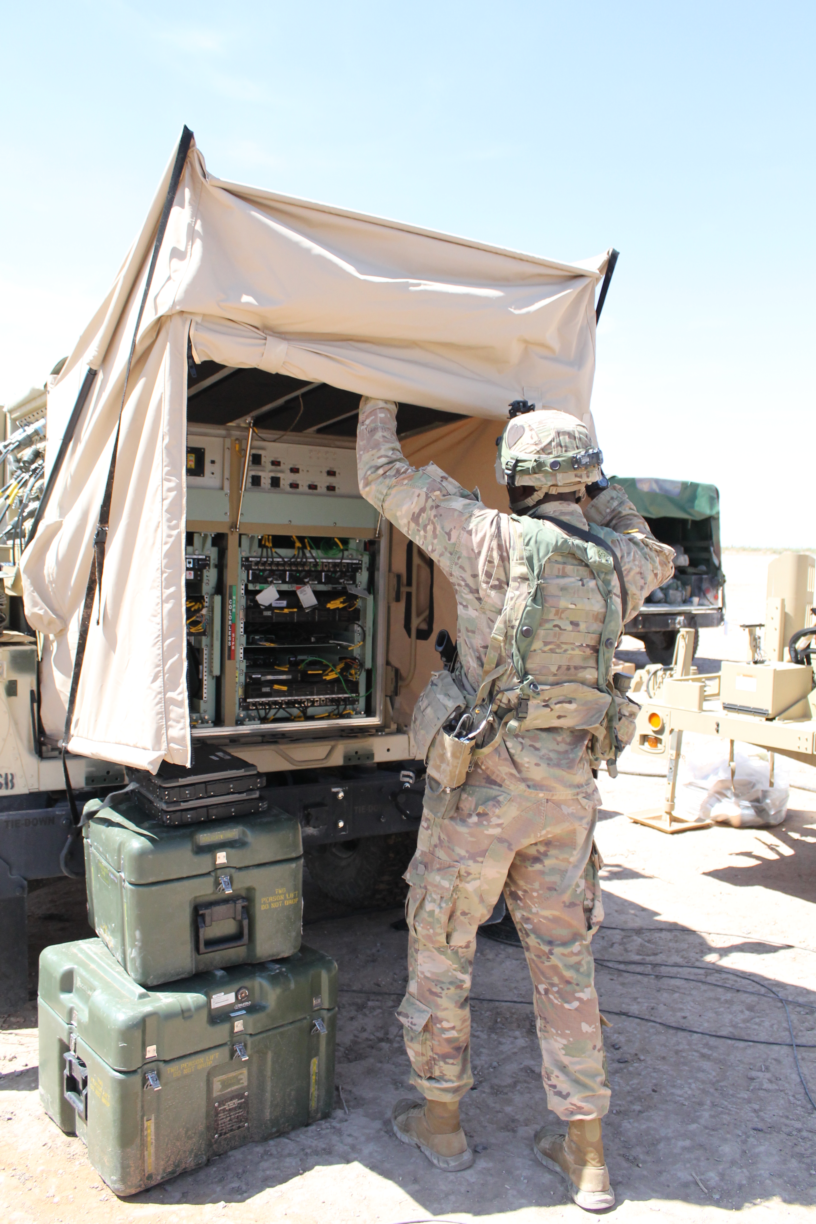 A soldier operates the Tactical Communications Node-Lite (TCN-L) at the NIE just outside of the TOC. The TCN-L was delivered by sling-load. TCN-L is essentially a smaller, more nimble node of the Warfighter Information Network-Tactical, the Army’s tactical network. Previously, WIN-T was so large it a 5-ton truck was used as the platform. It required a ladder to access the equipment. (Jen Judson/Staff)