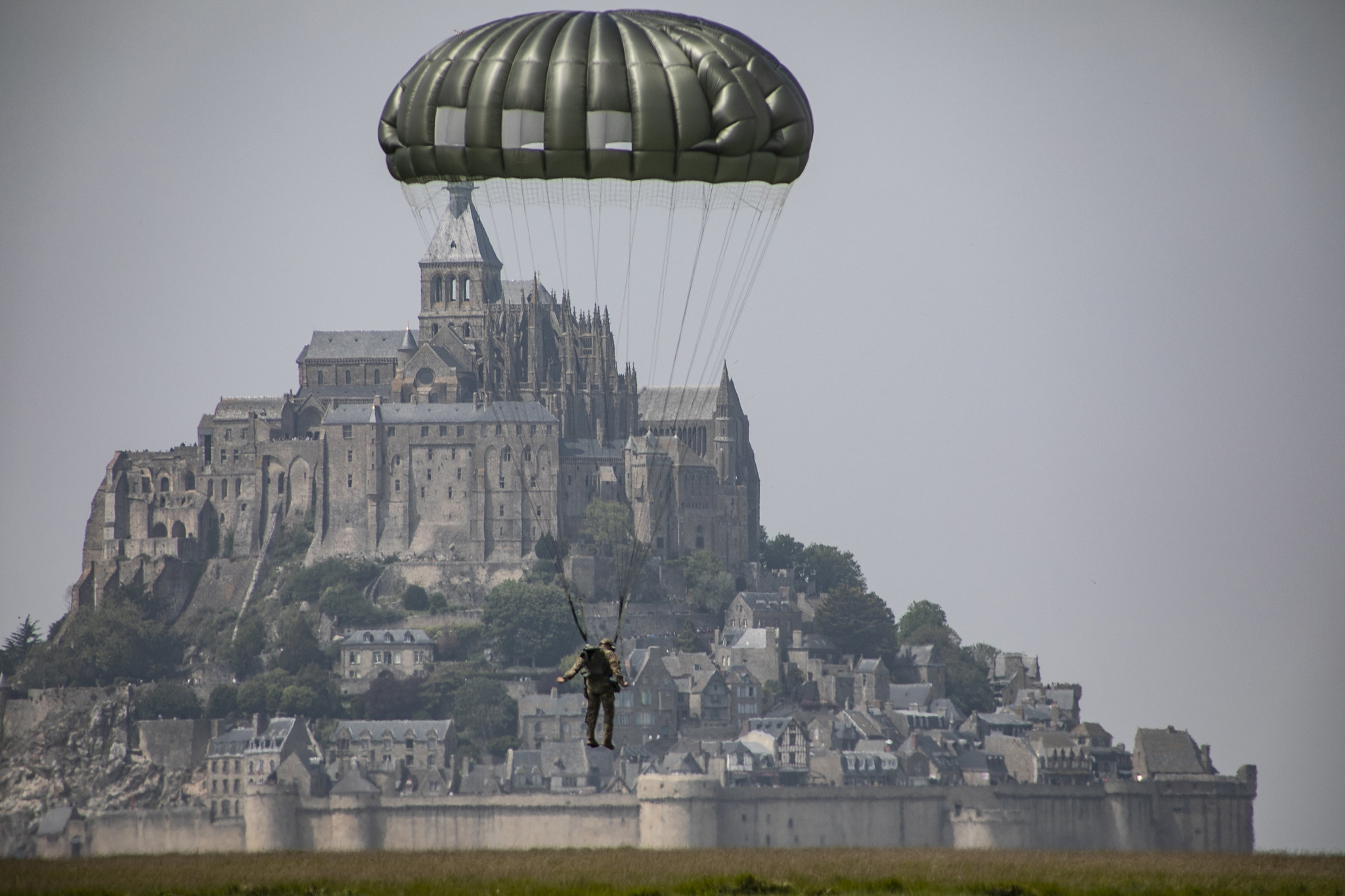 A paratrooper assigned to the U.S. Armys 10th Special Forces Group (Airborne) conducst an airborne operation near the island of Mont Saint Michel, Avranches, France, on May 18, 2019. This event comes at the invitation of the Mayor of Avranches in commemoration of World War ll special operations that laid the success for the Allied liberation of France, and a celebration of the strong Alliance between France and the United States. (Sgt. Alexis K. Washburn/Army)