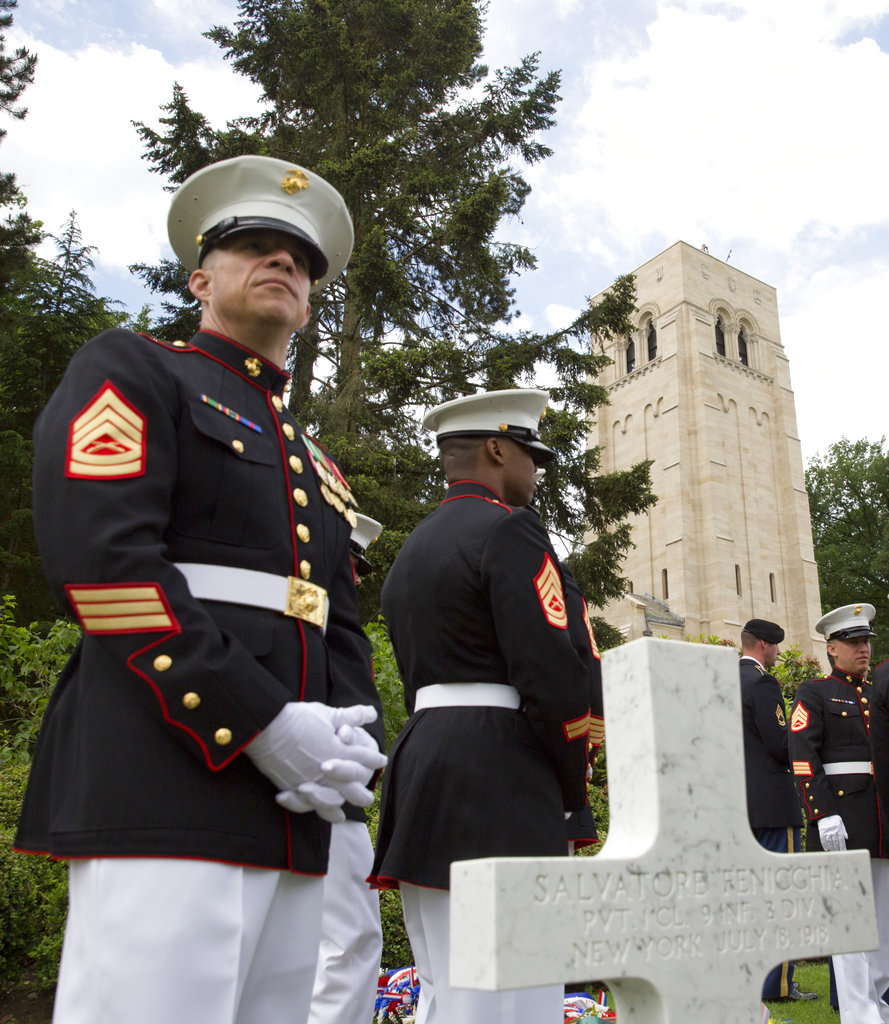 A U.S. Marine stands next to a headstone as he attends a Memorial Day commemoration at the Aisne-Marne American Cemetery in Belleau, France, Sunday, May 27, 2018. (Virginia Mayo/AP)