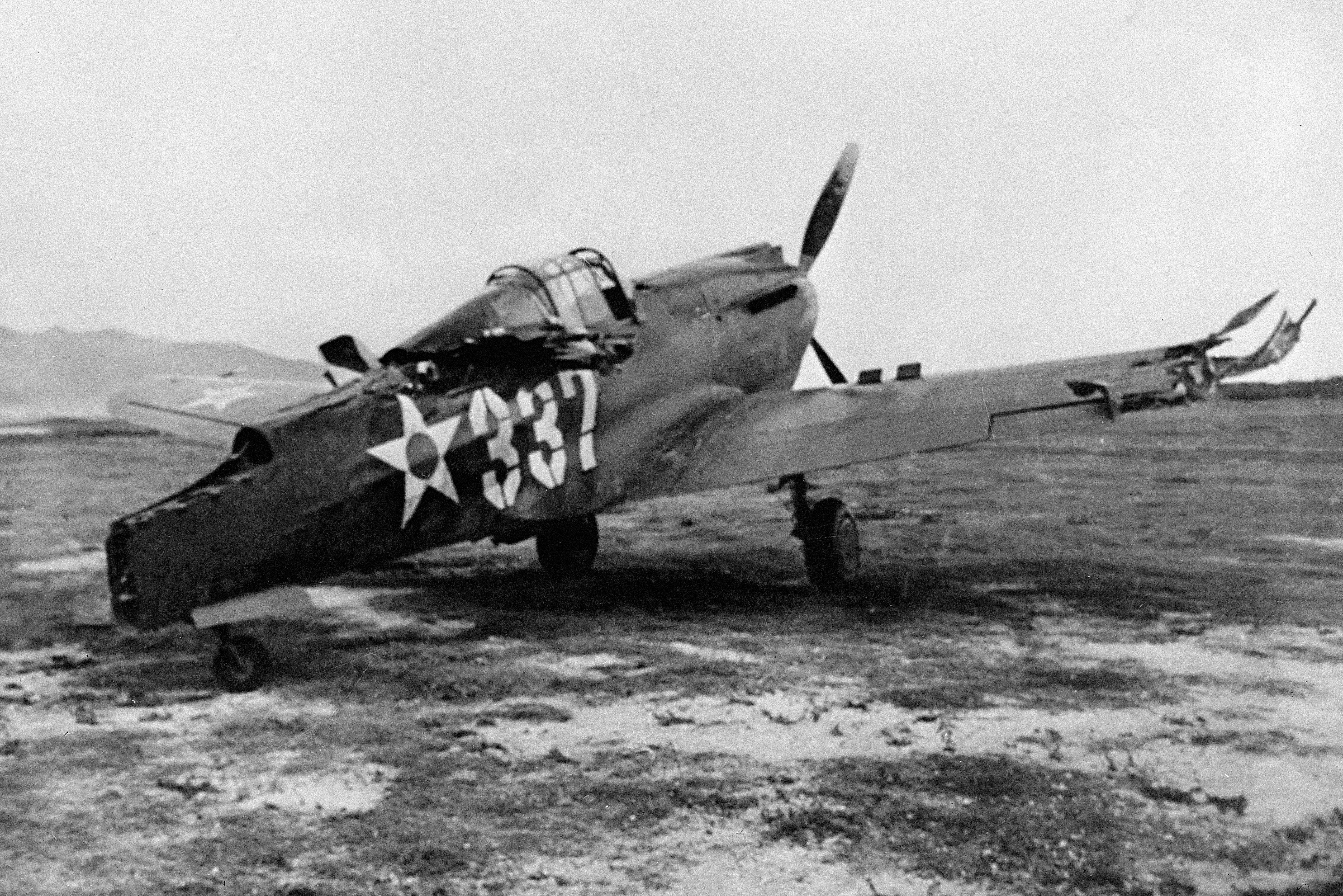 This is one of the first pictures of the Japanese raid on Pearl Harbor, Dec. 7, 1941. A P-40 plane which was machine-gunned while on the ground. (AP Photo)