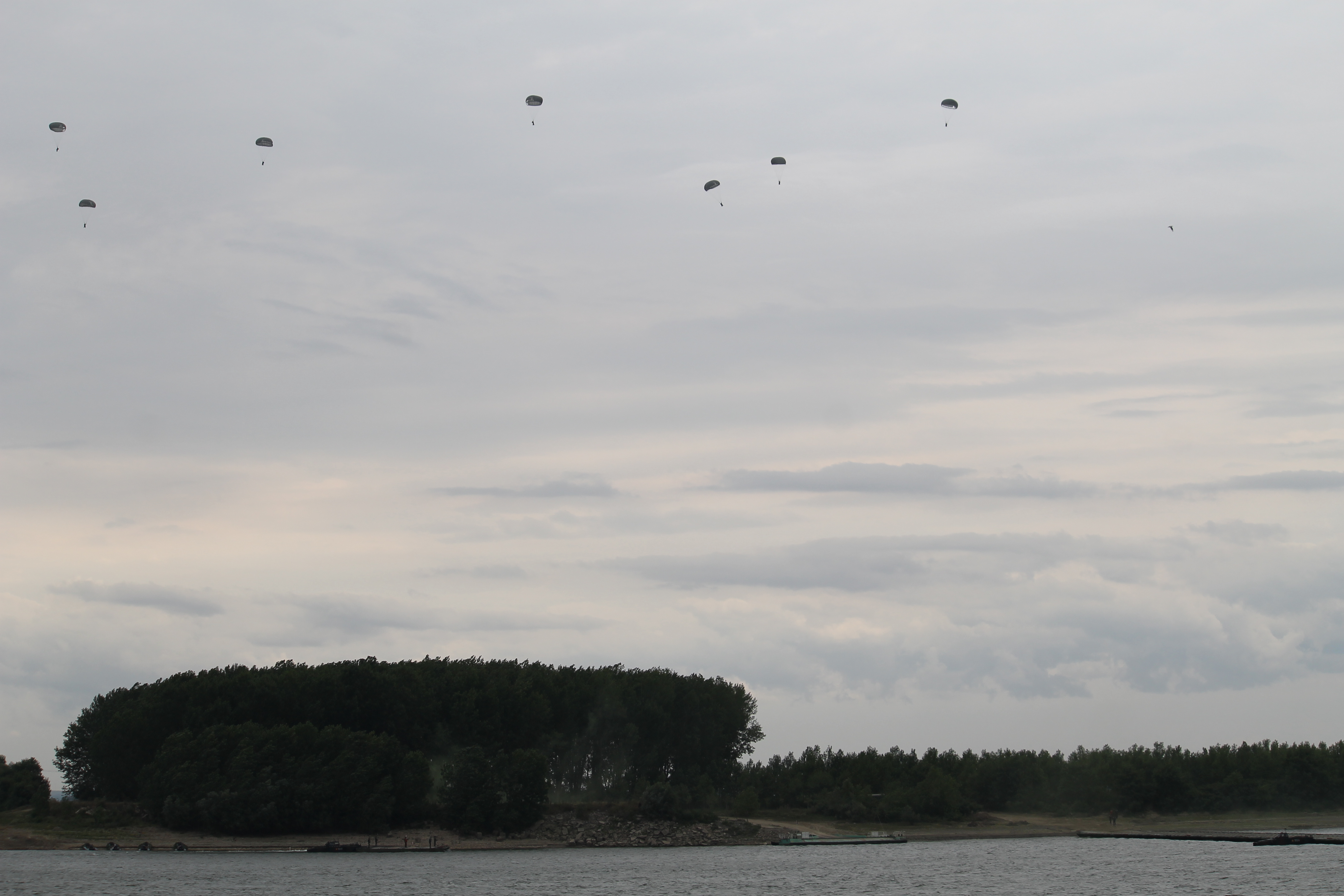 Romanian paratroopers practice their skills at the river crossing, jumping from C-130s and dropping on the side of the Danube where enemy forces were still attempting to regain lost territory. Normally, the entire operation would have occurred at night, but for the sake of showing off skills in an exercise, they practiced during the day. (Jen Judson/Staff)