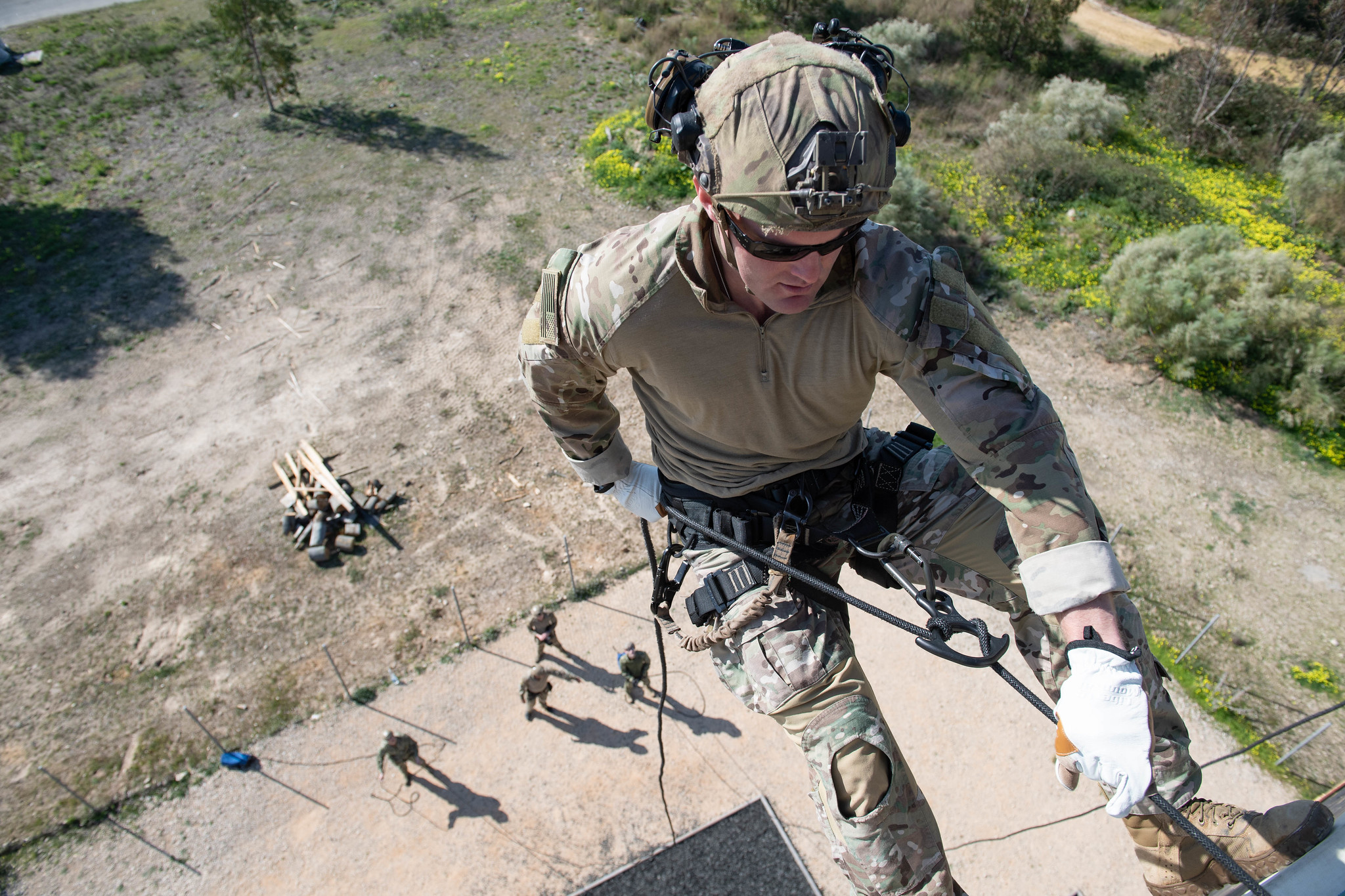 An explosive ordnance technician rappels down a tower at Rota, Spain, as part of helicopter rope suspension technique cast master renewal training and initial training for support personnel on Feb. 20, 2020. (Mass Communication Specialist 3rd Class Katie Cox/Navy)