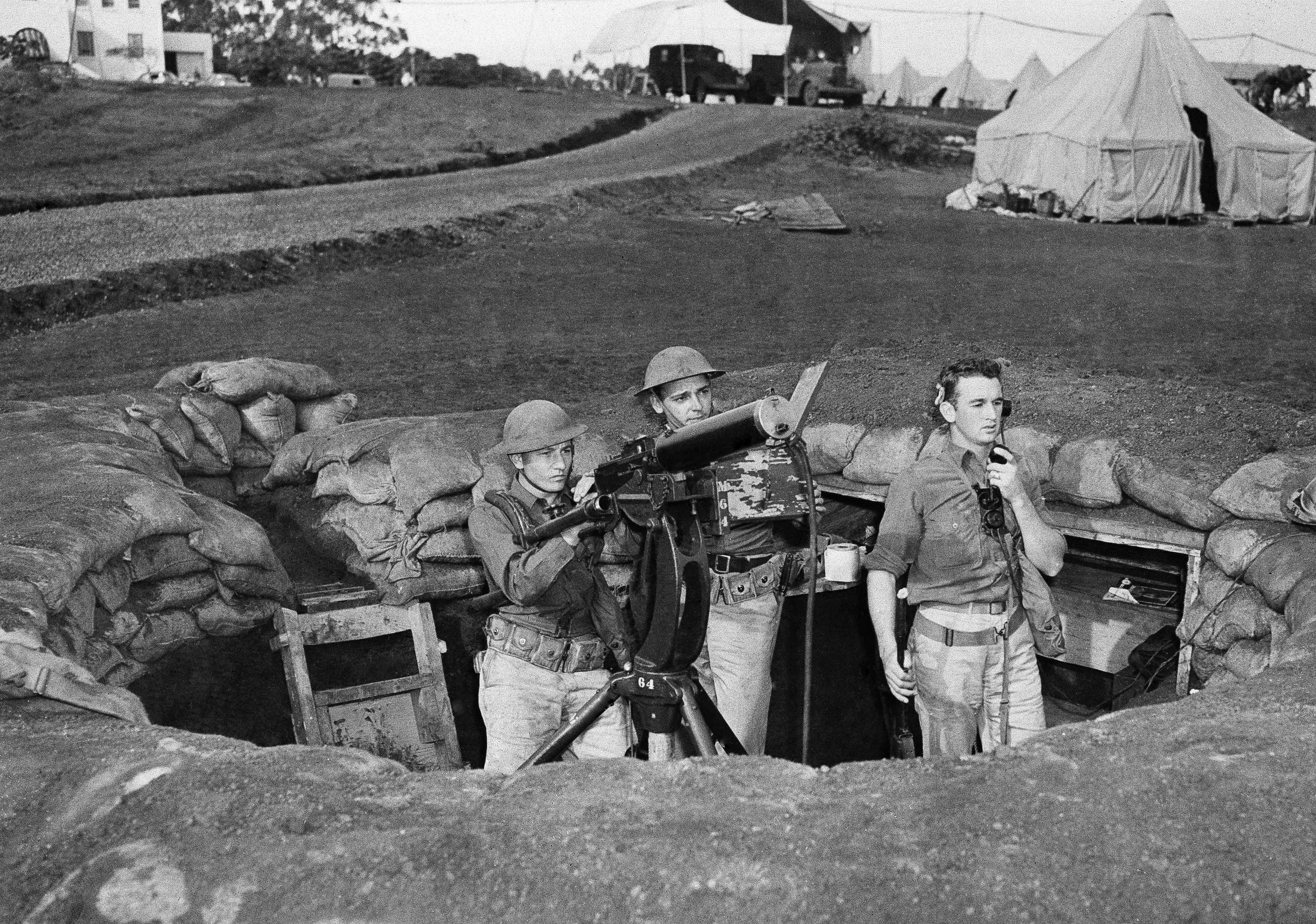 Troops man a machine gun nest at Wheeler Field, which adjoins Schofield Barracks in Honolulu, after the Japanese attack on the island of Oahu, Dec. 7, 1941. (AP Photo)