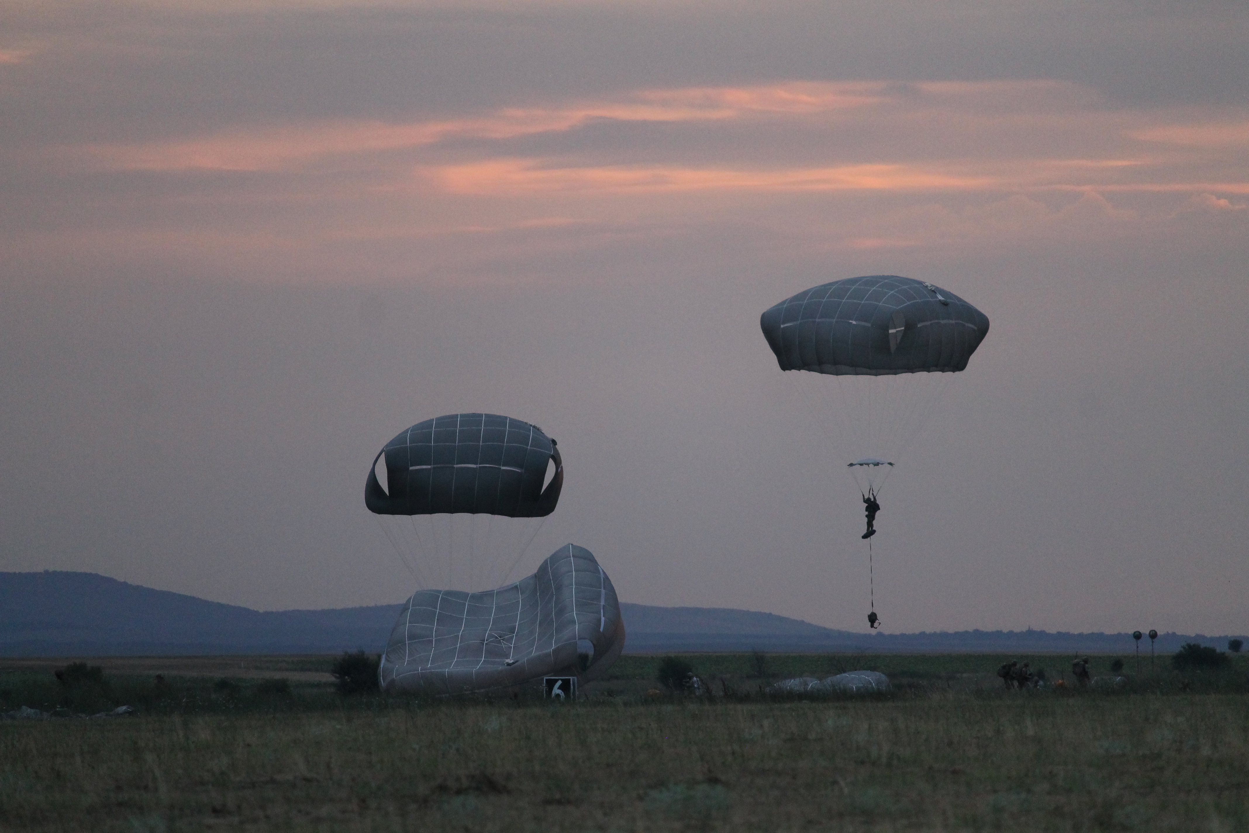 Paratroopers from the 173rd continue to land in the drop zone as night falls. (Jen Judson/Staff)