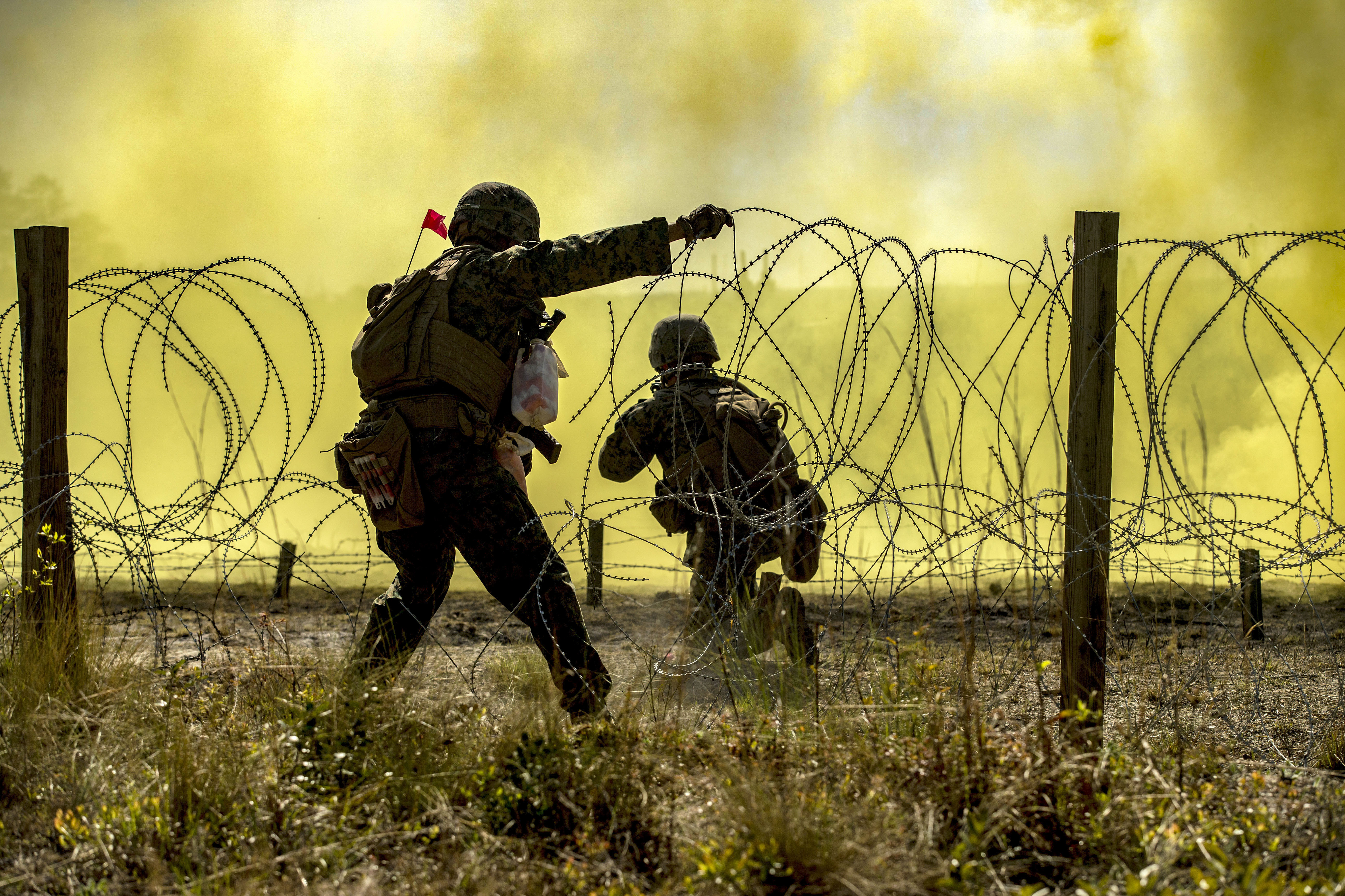 U.S. Marines with 1st Combat Engineer Battalion, 1st Marine Division breech through concertina wire during the Sapper Squad Competition on Camp Lejeune, N.C. April 19, 2018. Sapper Squads from each division accross the Marine Corps used their skills in various combat scenarios and operations. ( Pfc. Tyler M. Solak/Marines)