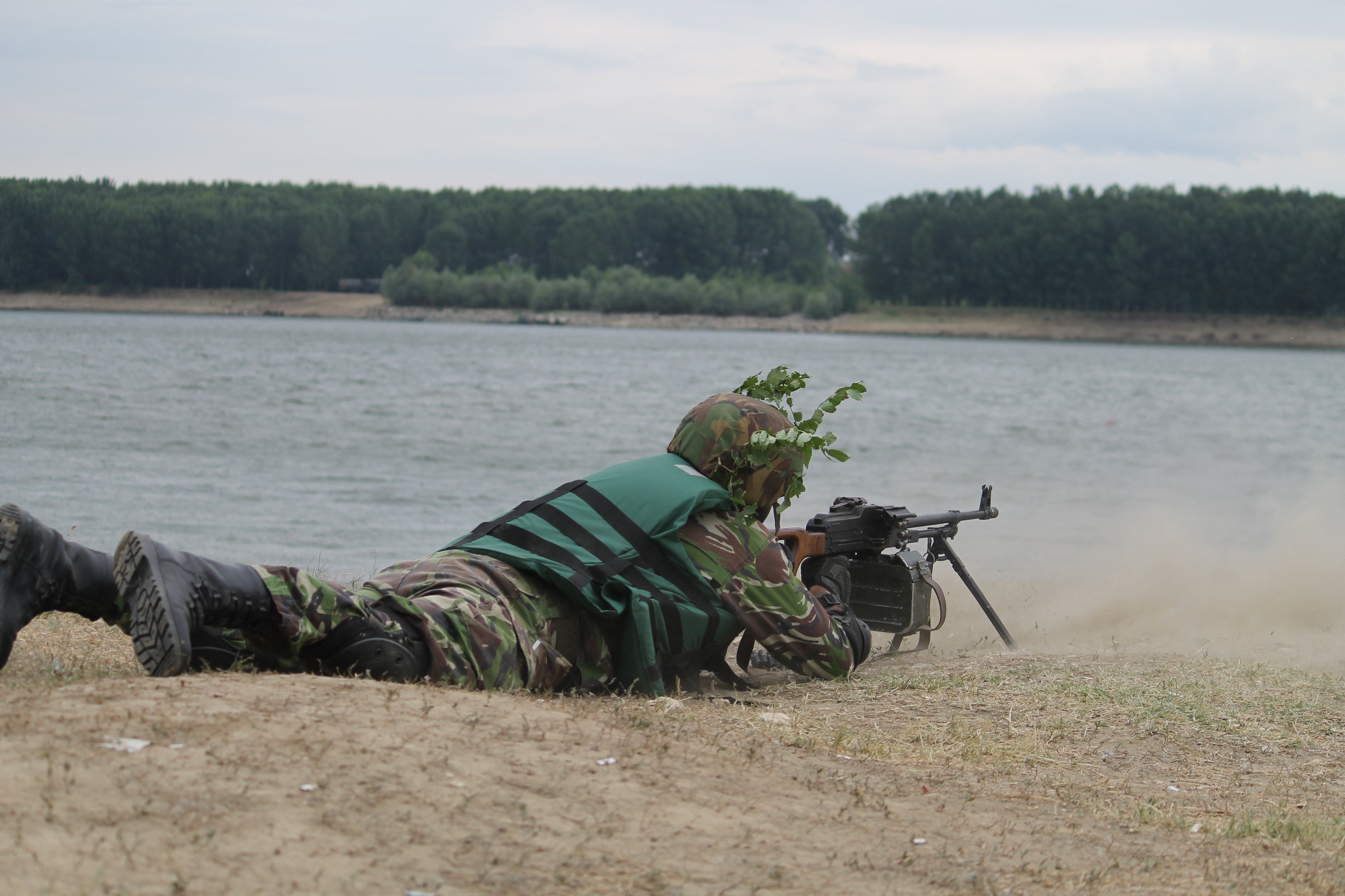 A soldier fires, providing cover for troops attempting to cross the Danube with a high-speed boat. (Jen Judson/Staff)