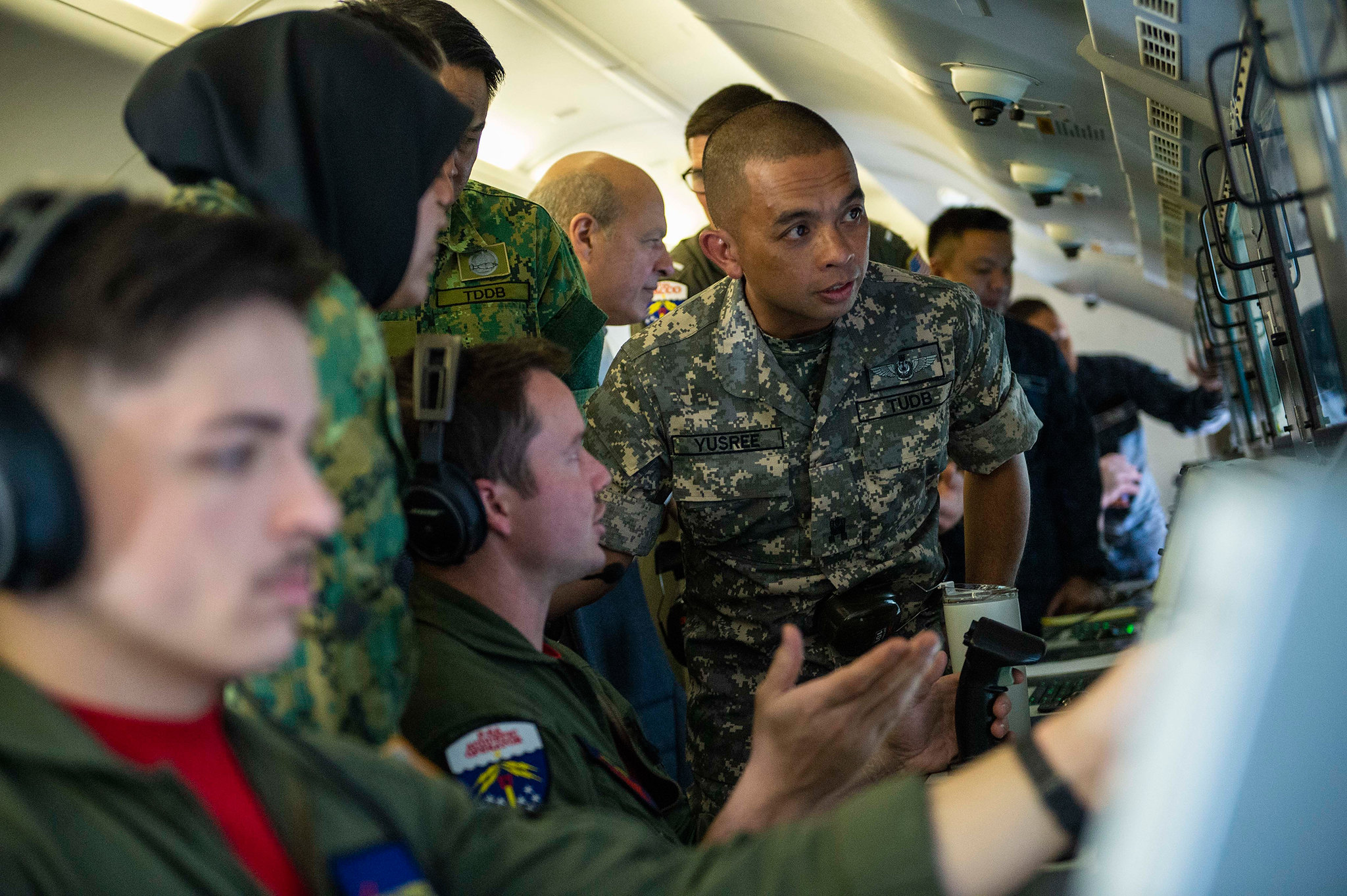Royal Brunei armed forces discuss aircraft capabilities with U.S. Navy sailors inside a P-8 Poseidon aircraft on Oct. 23, 2019, during a distinguished visitor tour of the aircraft in support of Cooperation Afloat Readiness and Training (CARAT) Brunei at Rimba Air Base. (Mass Communication Specialist 2nd Class Christopher A. Veloicaza/Navy)