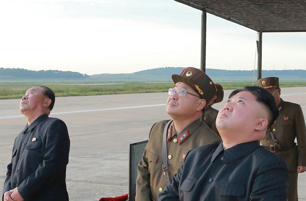 North Korean leader Kim Jong Un, right, watches what was said to be the test launch of an intermediate-range Hwasong-12 missile at an undisclosed location in North Korea in this undated image. The North tested that missile type Aug. 28, 2017. (Korean Central News Agency/Korea News Service via AP)