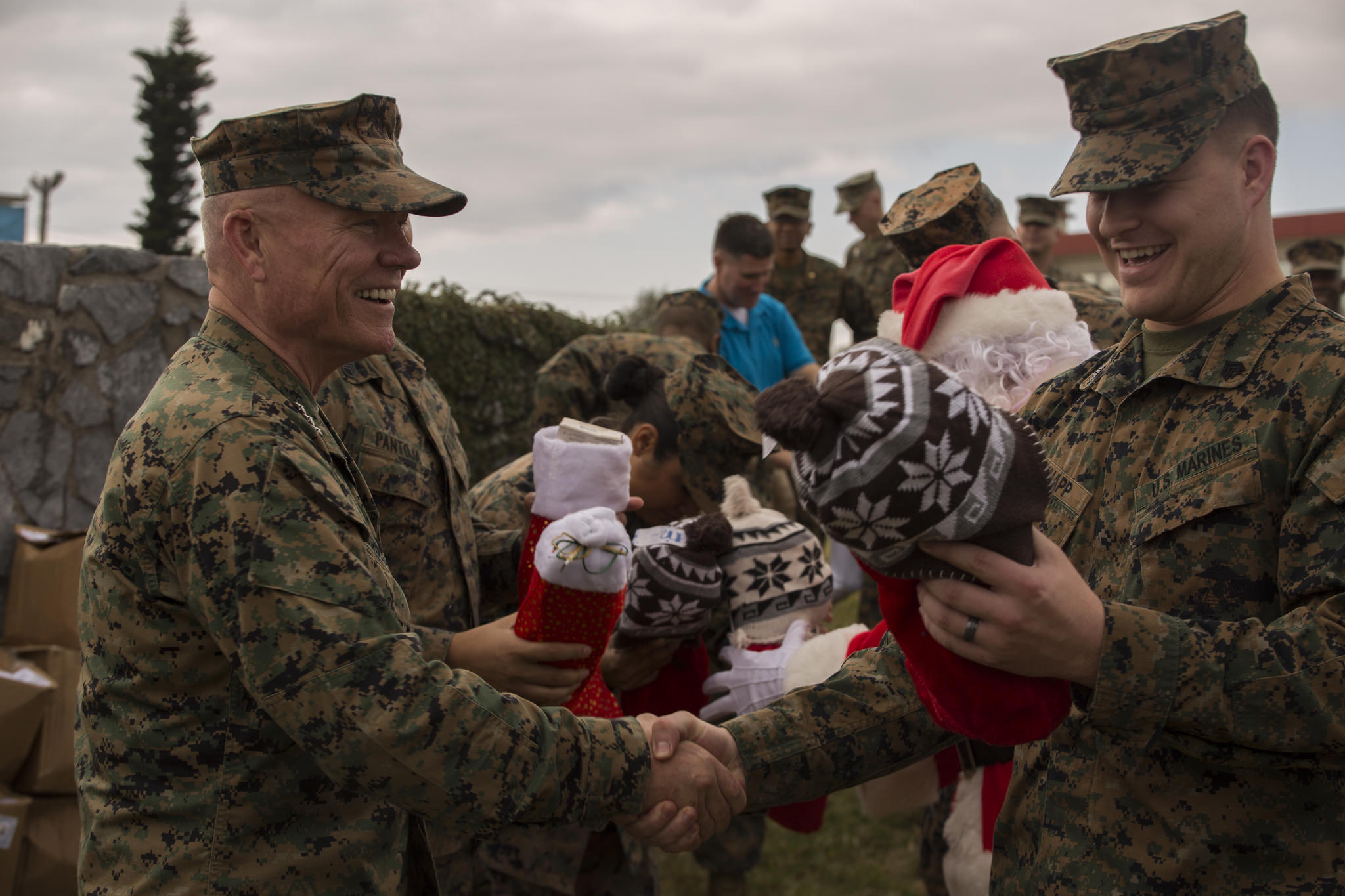 Lt. Gen. Lawrence D. Nicholson, the commanding general of III Marine Expeditionary Force, hands out Christmas stockings to Marines at Camp Courtney, Okinawa, Japan, Dec. 22, 2017. (Cpl. Nelson Duenas/Marine Corps)