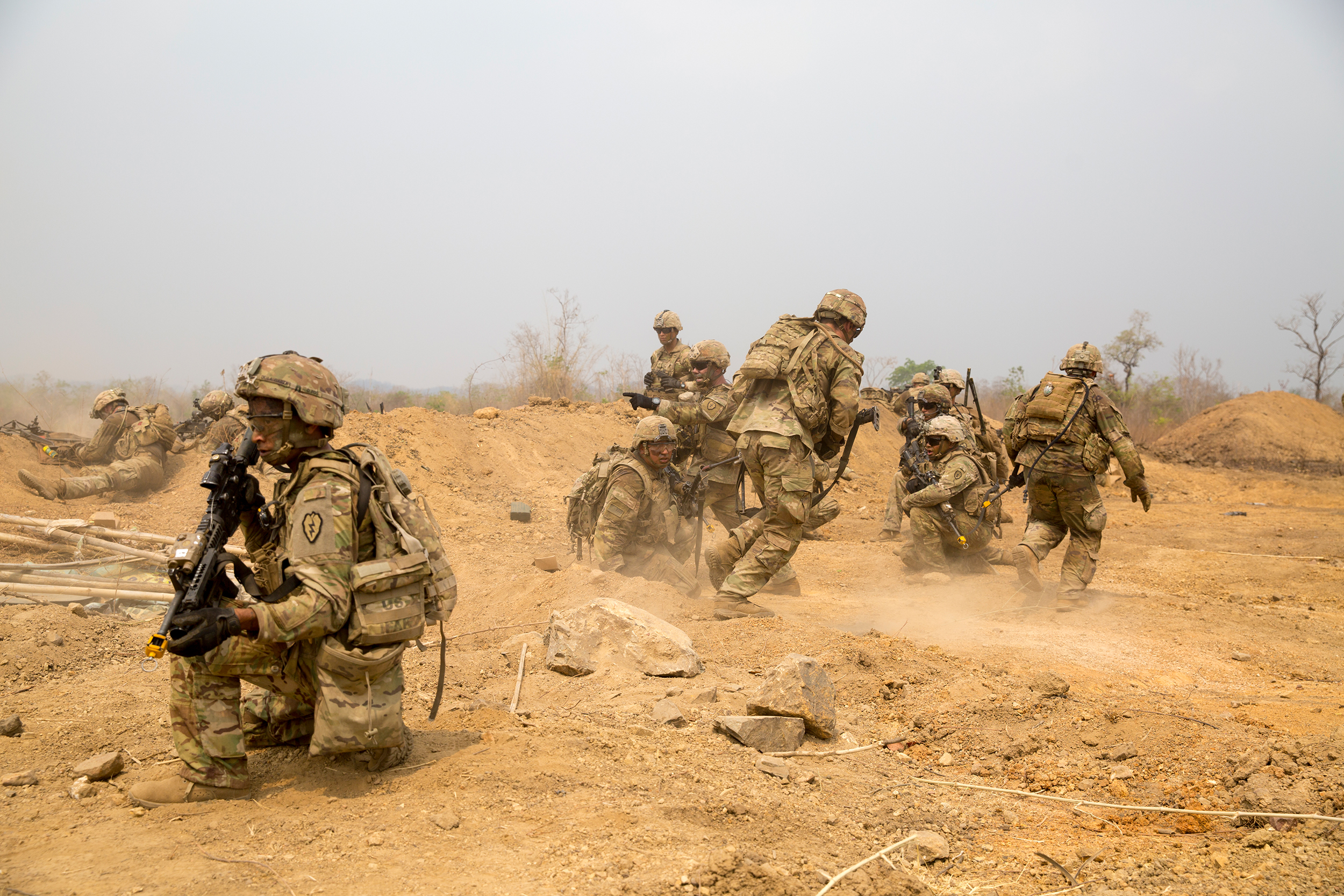 U.S. Army soldiers with 25th Infantry Division, 3rd Squadron, 4th Cavalry Troop, crouch behind a dirt berm after a Bangalore torpedo explosion on March 2, 2020, while preparing for a combined arms live fire exercise during Exercise Cobra Gold 2020 at Ban Dan Lan Hoi, Kingdom of Thailand. (Lance Cpl. Kaleb Martin/Marine Corps)