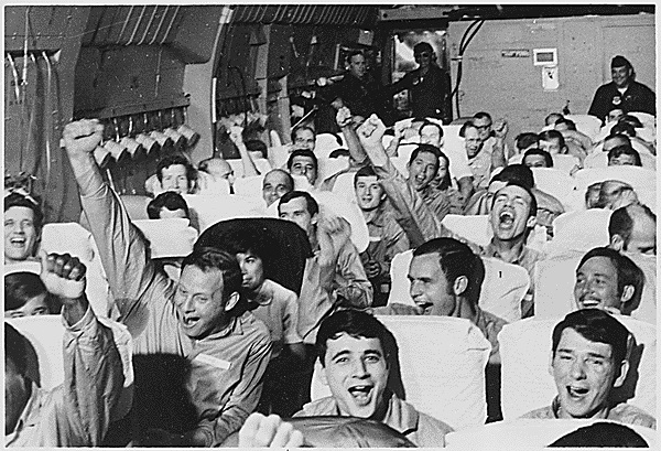 American servicemen, all former prisoners of war, cheer as their plane takes off for home from an airfield near Hanoi on Feb. 12, 1973. In all, 591 POWs were released after the Paris Peace Agreement was signed. (National Archives/Marine Corps)