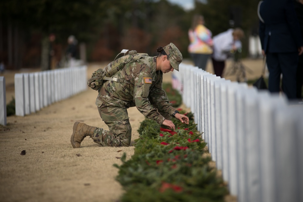 A soldier places a wreath next to a marker at the Fort Jackson National Cemetery in South Carolina on Dec. 14, 2019, during a Wreaths Across America event. (Saskia Gabriel/Fort Jackson)
