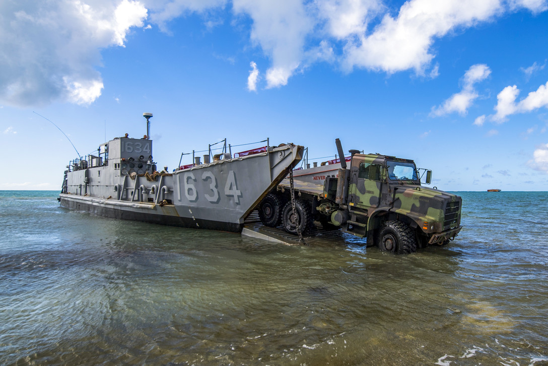 A U.S. Army light medium tactical vehicle assigned to the 9th Mission Support Command, Army Reserves, Honolulu, is driven on a U.S. Naval Landing Craft Utility operating out of the USS Ashland (LSD 48) during beach-front loading and unloading of vehicles on Saipan, Commonwealth of the Northern Mariana Islands, Nov. 12, 2018, as part of the Super Typhoon Yutu relief effort. (Tech. Sgt. Christopher Ruano/Air Force)
