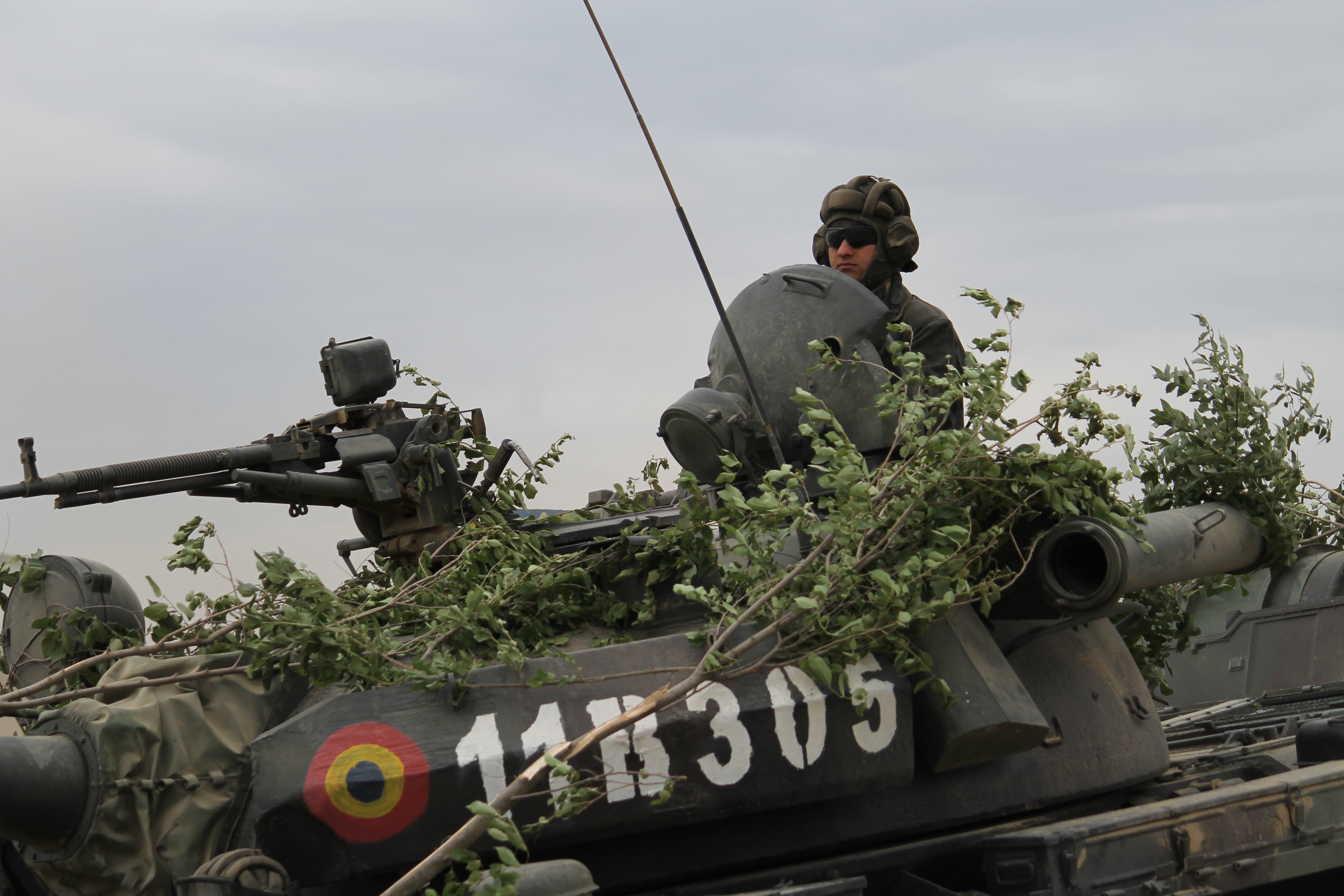A Romanian soldier rides in a T-85 main battle tank across the bridge during the river crossing. (Jen Judson/Staff)