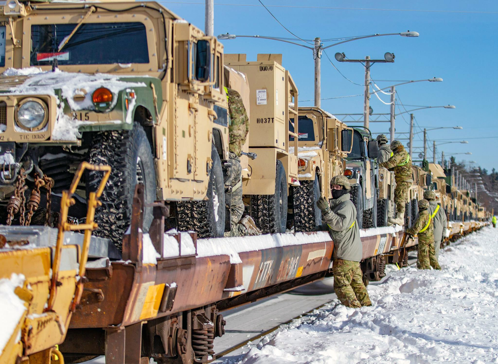 Soldiers from 10th Mountain Division take the final steps to make sure the vehicles on the railhead are ready for transport to Fort Polk, La., on Feb. 14, 2019. (Army)