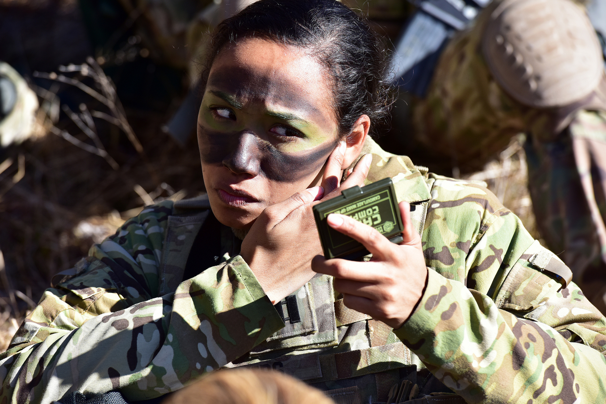 Capt. Julissa Myers puts the finishing touches to her face paint camouflage in preparation a blank-fire exercise as part of Lipizzaner V at Pocek Range in Postonja, Slovenia, March 12, 2019. (Paolo Bovo/Army)