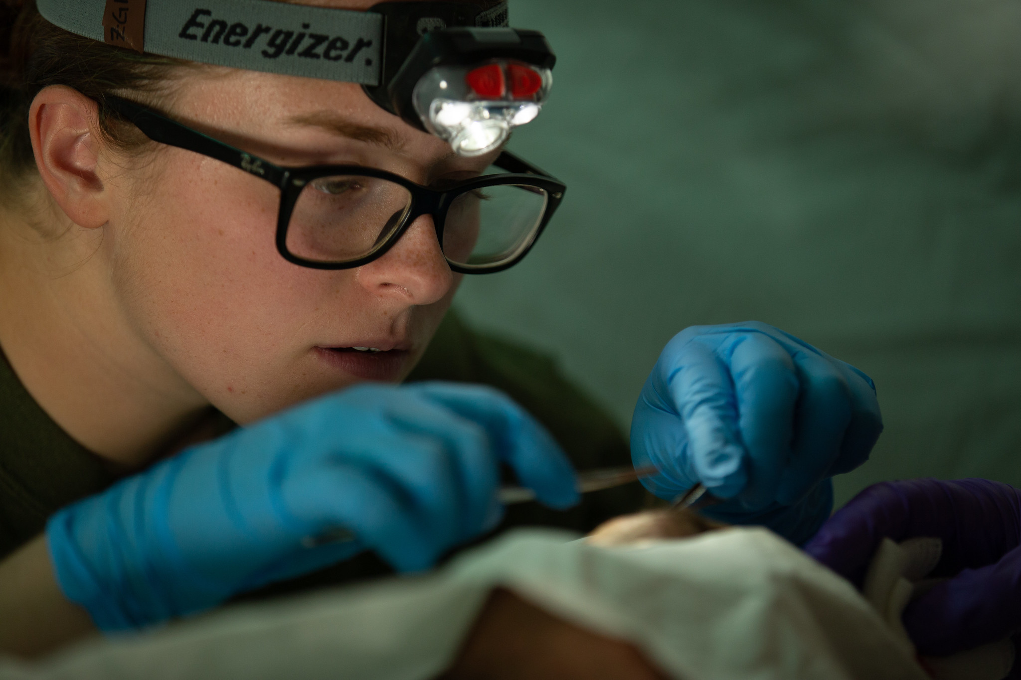 Hospitalman 3rd Class Kiera King performs a live suture on a patient at Camp Wilson, Marine Corps Air Ground Combat Center, Twentynine Palms, Calif., Nov. 8, 2019. (Pfc. Patrick King/Marine Corps)