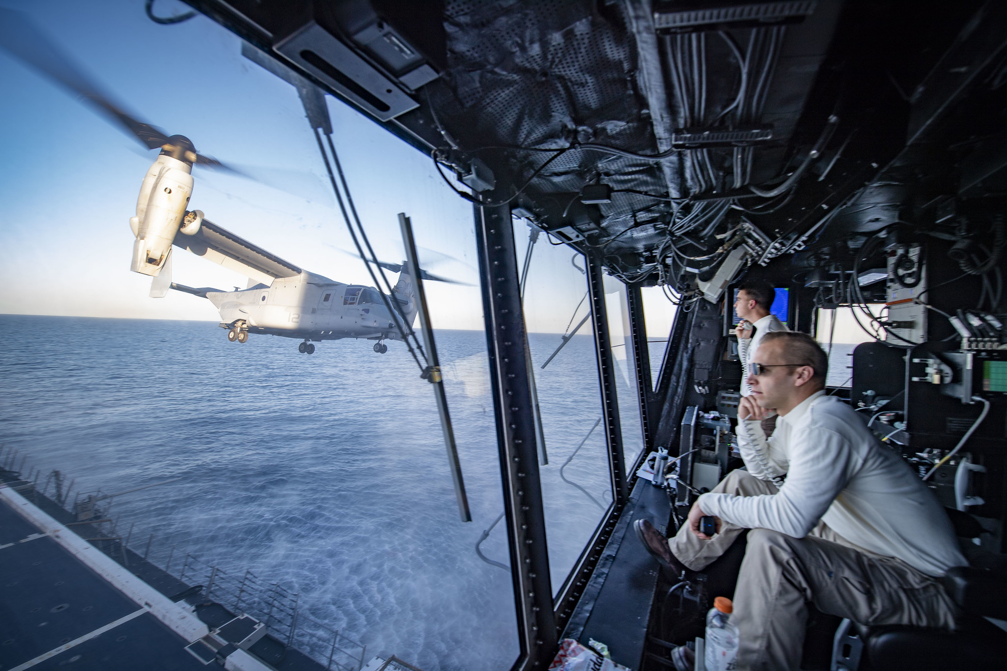 Lt. Cmdr. Brooks Rogers, the air boss aboard the amphibious transport dock ship USS Portland (LPD 27), watches flight operations Feb. 11, 2020, as an MV-22B Osprey takes off from Portland's flight deck to simulate an air assault on Camp Pendleton, Calif., during Exercise Iron Fist 2020. (Mass Communication Specialist 2nd Class Jessica Paulauskas/Navy)
