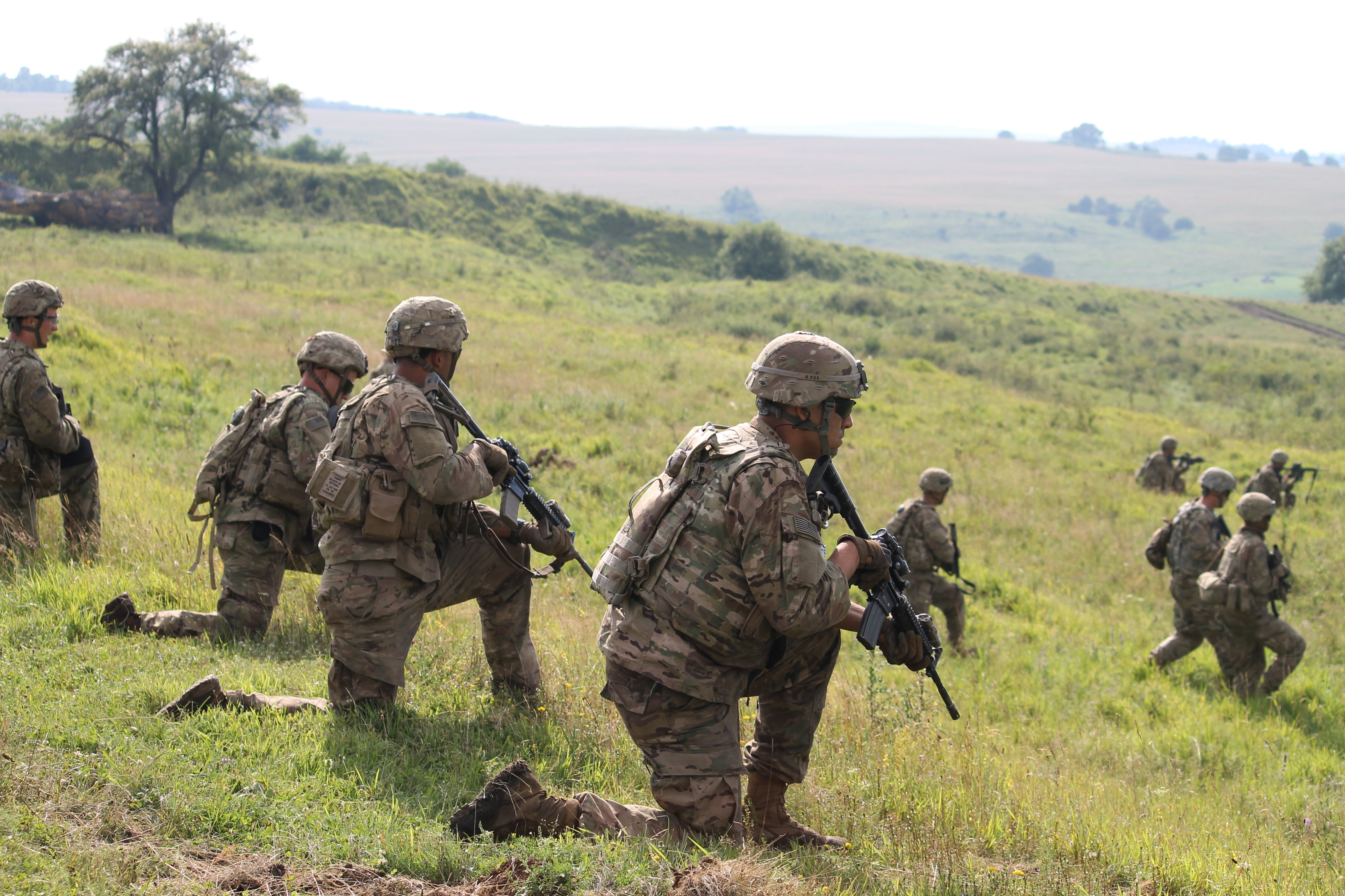 Friendly infantry consisting of U.S. and Croatian companies with a Montenegrin platoon slip into position on the battlefield, establishing strong points midway down the hill across from the enemy positioned up the opposite hill. (Jen Judson/Staff)
