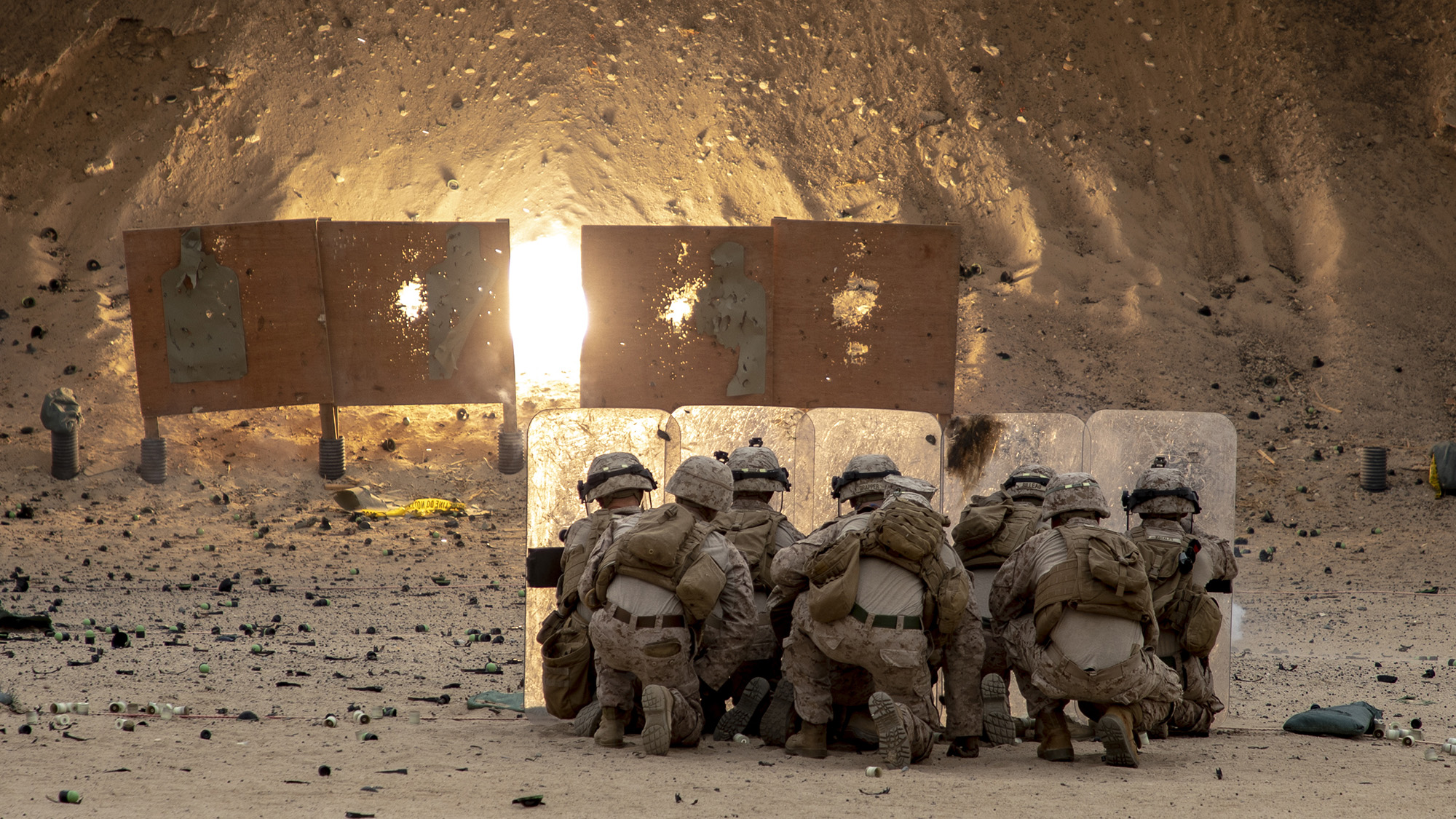 Marines with 2nd Battalion, 7th Marines, assigned to Special Purpose Marine Air-Ground Task Force – Crisis Response – Central Command (SPMAGTF-CR-CC) 19.2, take cover while throwing non-lethal grenades during a non-lethal weapons training exercise on Jan. 18, 2020, in Kuwait. (Sgt. Robert G. Gavaldon/Marine Corps)