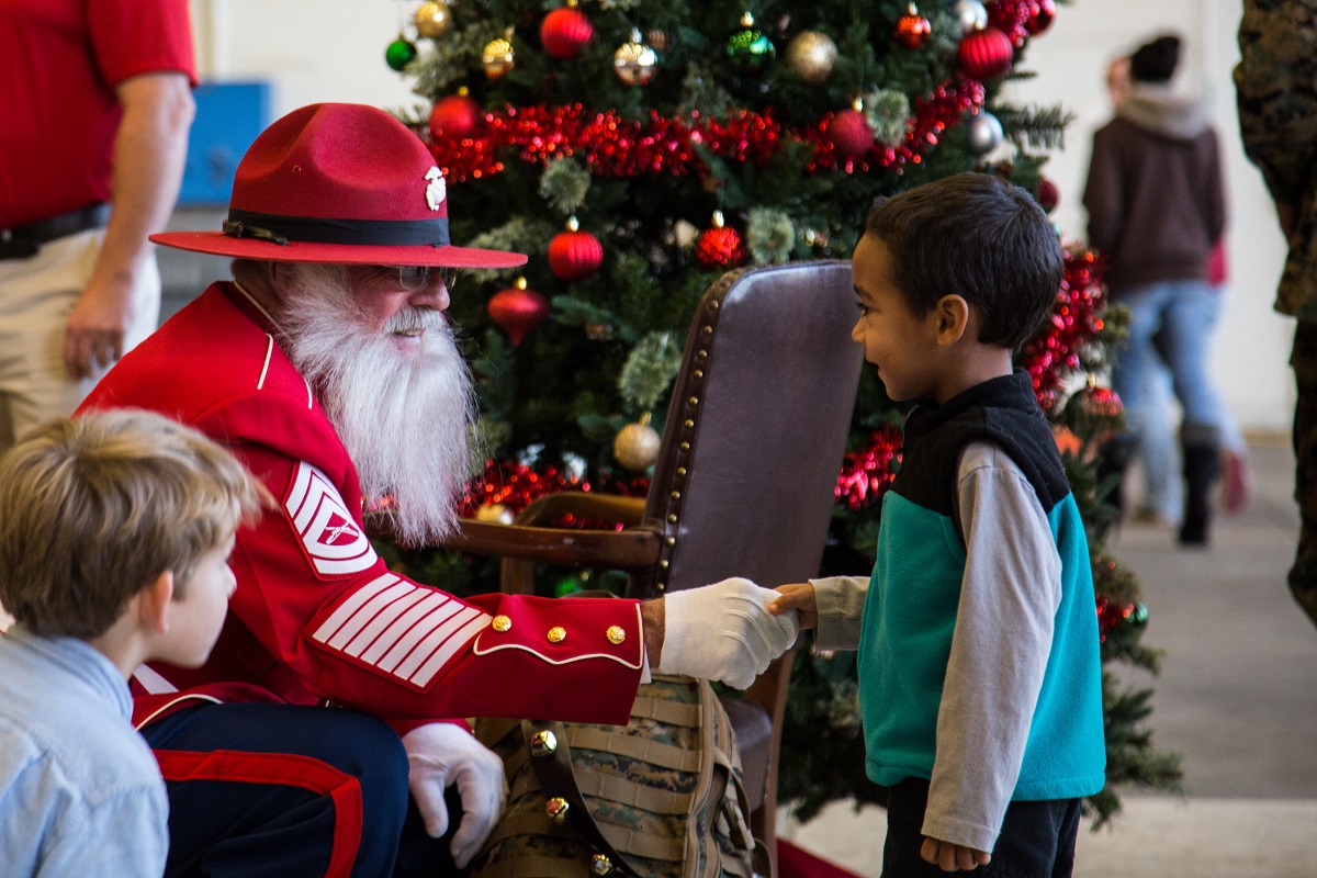 Gunny Claus greets children at a Christmas party host by Marine Aerial Refueler transport Squadron (VMGR) 252 at Marine Corps Air Station Cherry Point, N.C., Dec. 1, 2017. The Marines and family of VMGR-252 had the celebration to enjoy the holiday season and build unit cohesion. (Lance Cpl. Ethan Pumphret/Marine Corps)