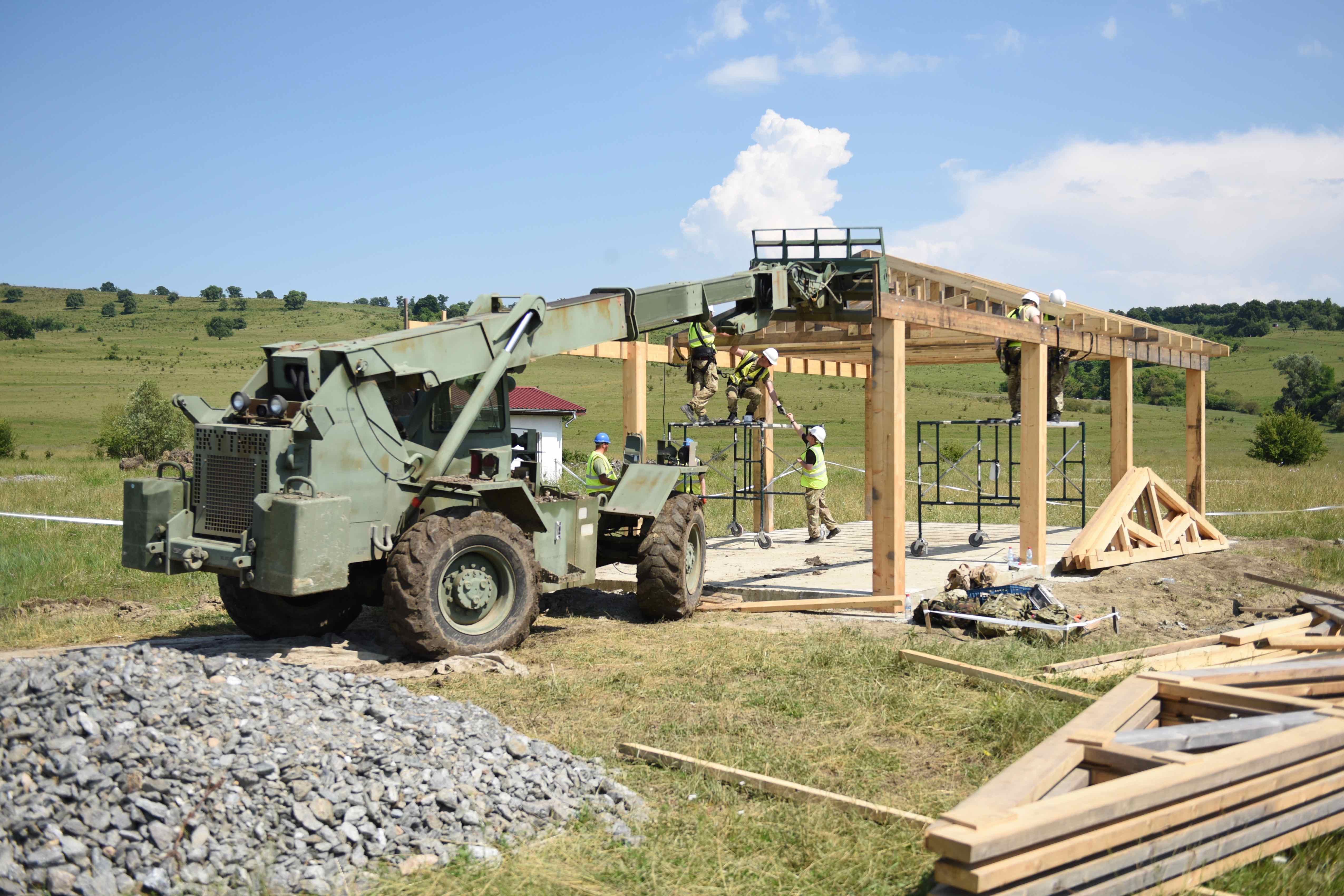 The multipurpose shelter, which was almost fully constructed by July 14, is being assembled by soldiers from the U.K. and Romania. British soldiers specialized in building structures during Resolute Castle. Building training ranges on the Romanian site will have a lasting impact, by providing both new state-of-the-art facilities as well as training experiences for engineers assigned to the building. (Jen Judson/Staff)