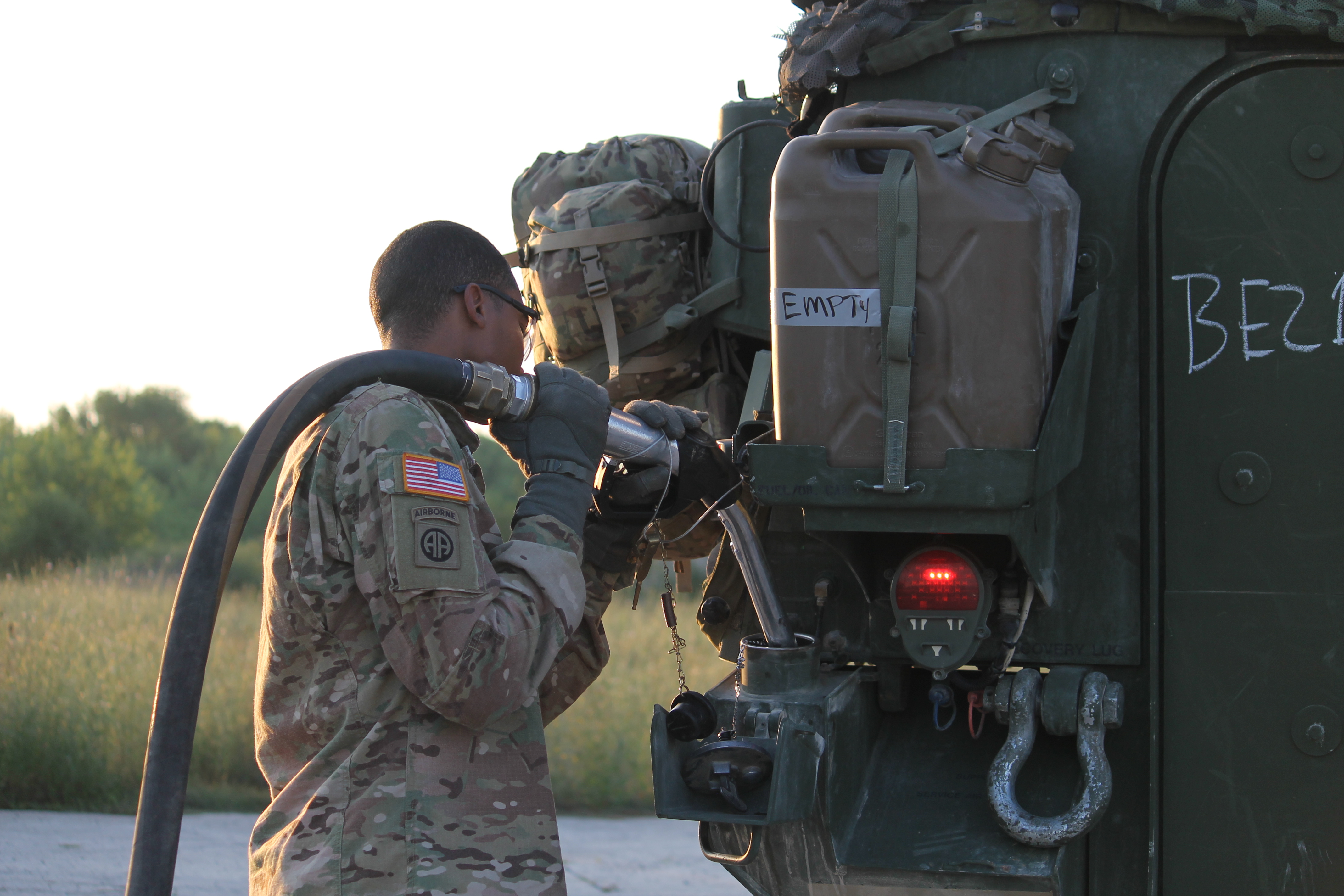 A soldier refuels the U.S. Stryker, preparing the vehicle to head over to the seized airfield, where the 173rd awaits support. (Jen Judson/Staff)
