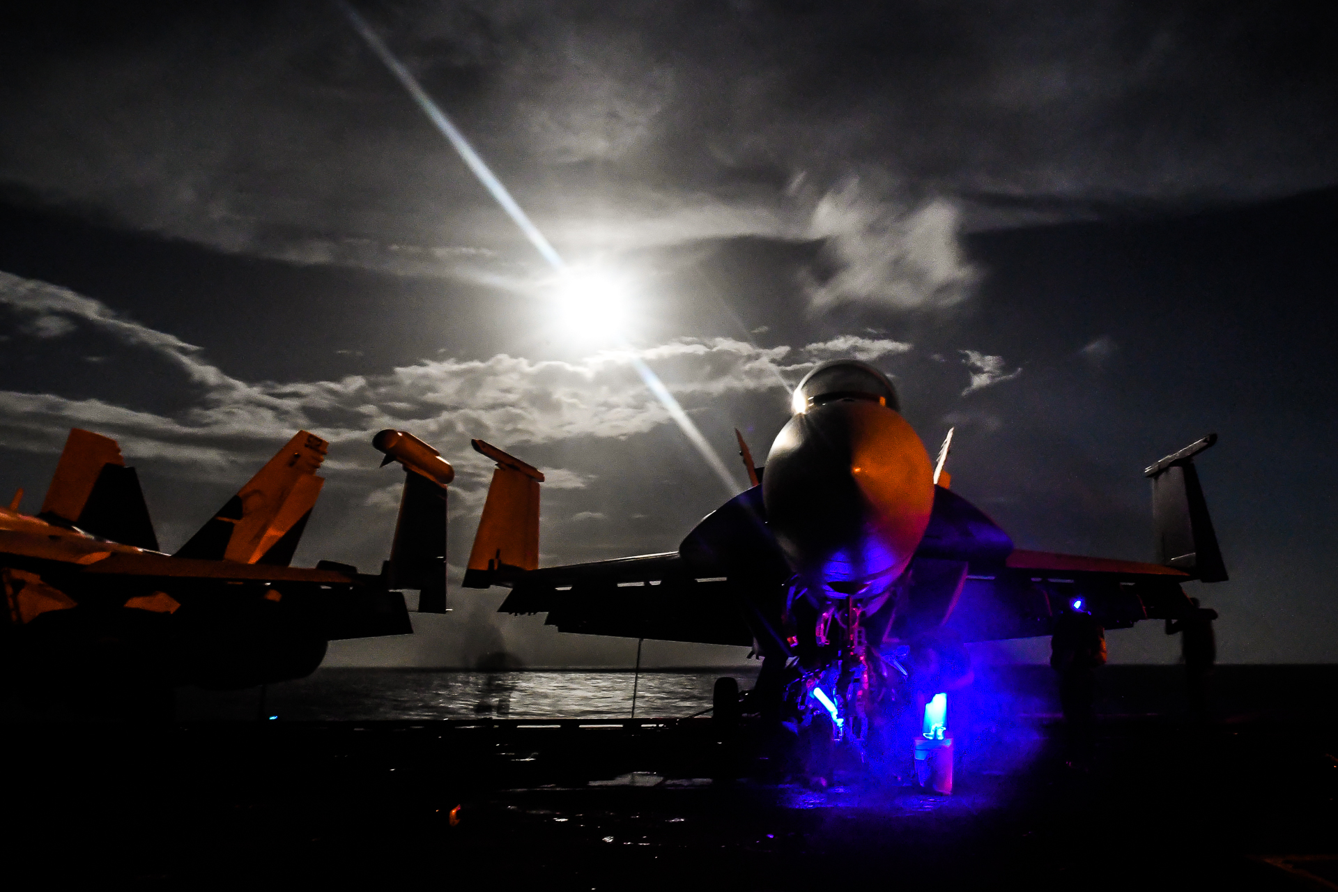 Sailors inspect the landing gear of an F/A-18F Super Hornet, assigned to the