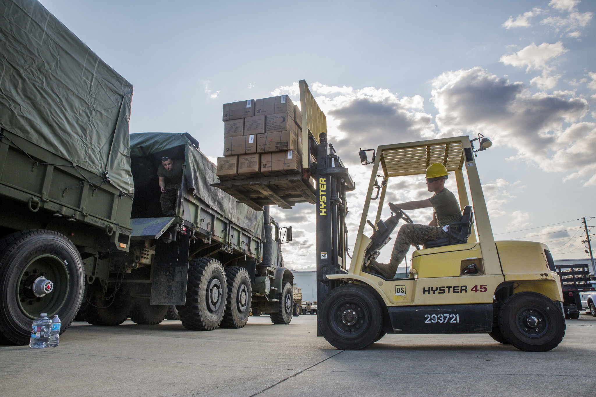 Marines from 3rd Force Reconnaissance Company, 4th Marine Division, Marine Forces Reserve, load a spare tire onto an MTVR 7-ton truck at the Alabama Army National Guard Fort Whiting Armory in Mobile, Ala., Sept. 9, 2017, in preparation of rescue missions following Hurricane Irma. (Lance Cpl. Niles Lee/Marine Corps)