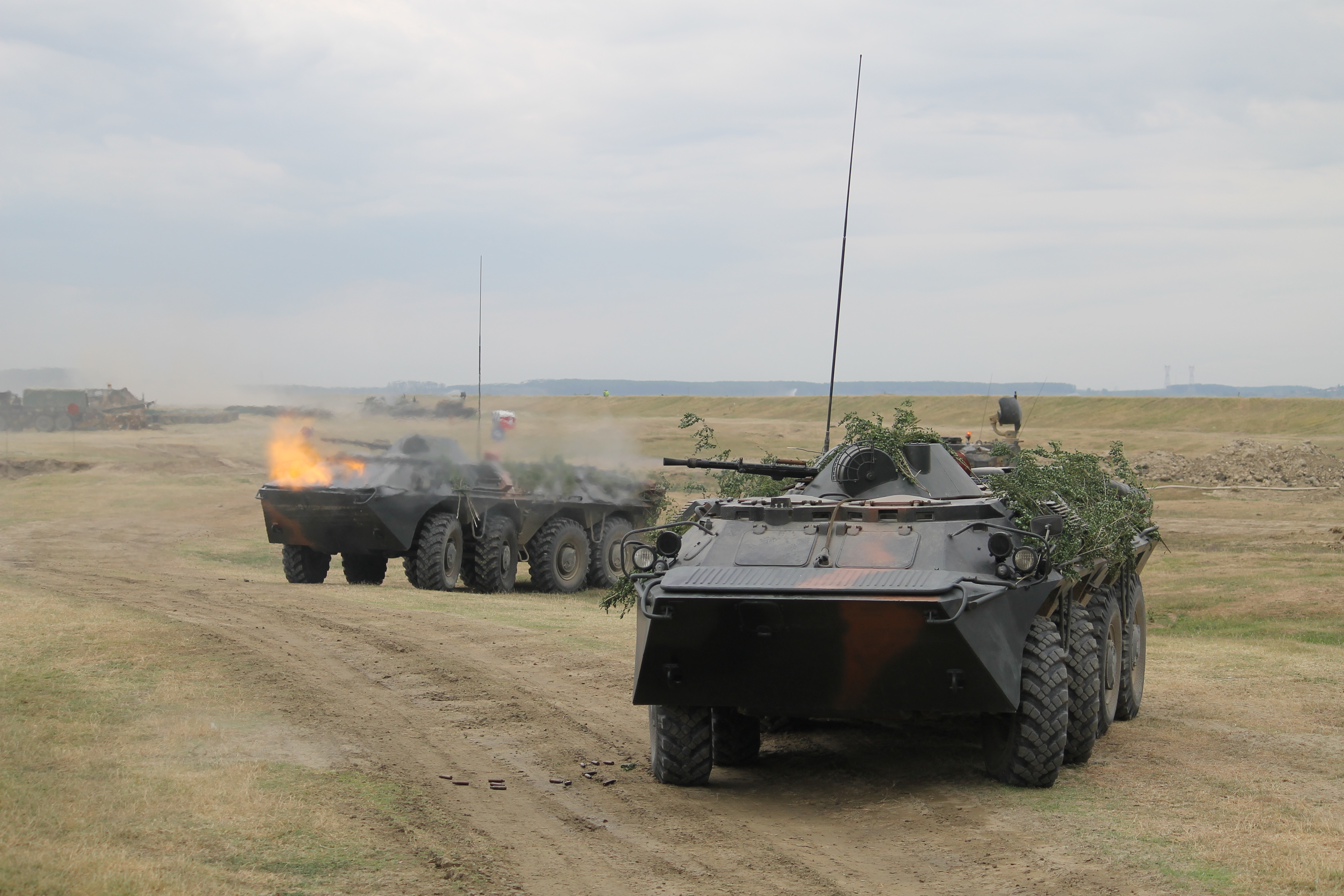 Romanian Zimbru armored personnel carriers firing on the banks of the Danube continue to beat back enemy forces and to secure the bridge for Romanian troops, other combat vehicles and U.S. Stryker fighting vehicles from the 2nd Cavalry Regiment to cross the river later in the exercise. (Jen Judson/Staff)