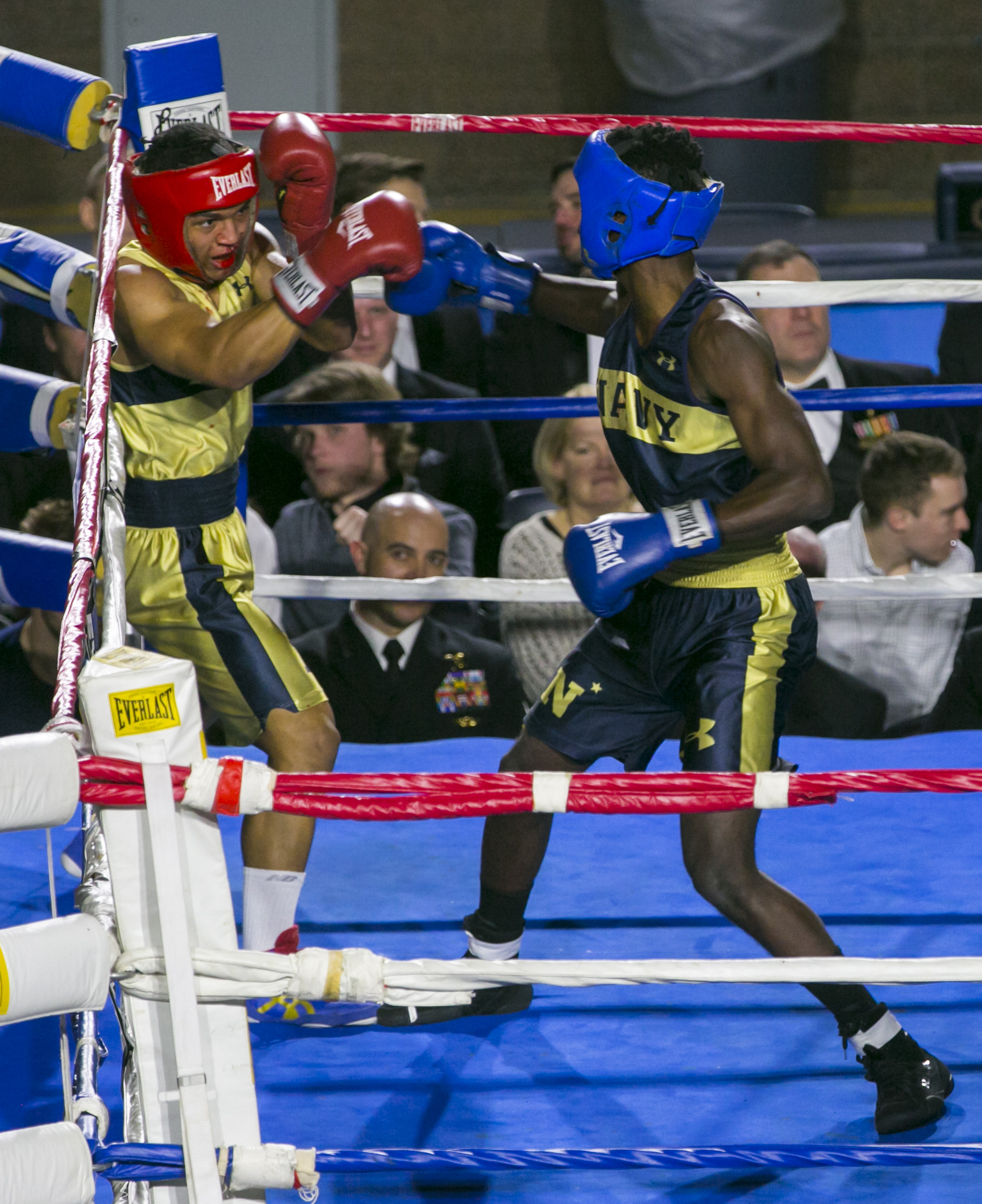 Kendell Louis (in blue) from Miami, FL backs Jordon McDaniel (in gold) from East Chicago, IN into the corner during the 147-lb weight class fight at the United States Naval Academy's 77th Brigade Boxing Championships held on Feb. 23, 2018. Louis won the bout. (Alan Lessig/Staff)