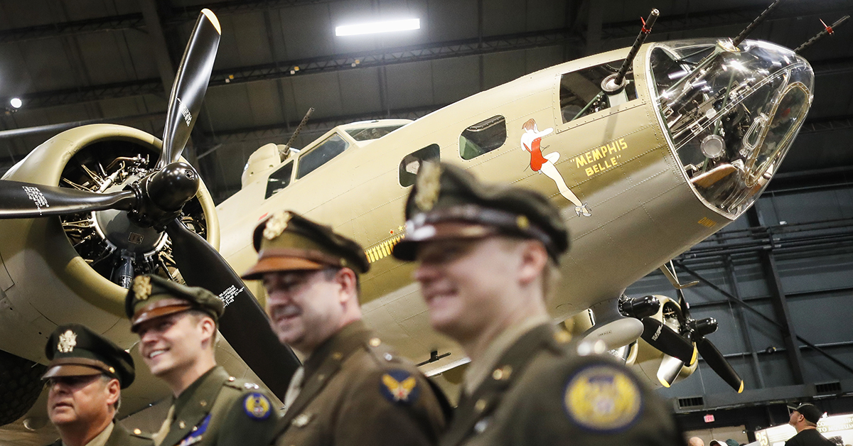 Visitors and period re-enactors gather beside the Memphis Belle, a Boeing B-17