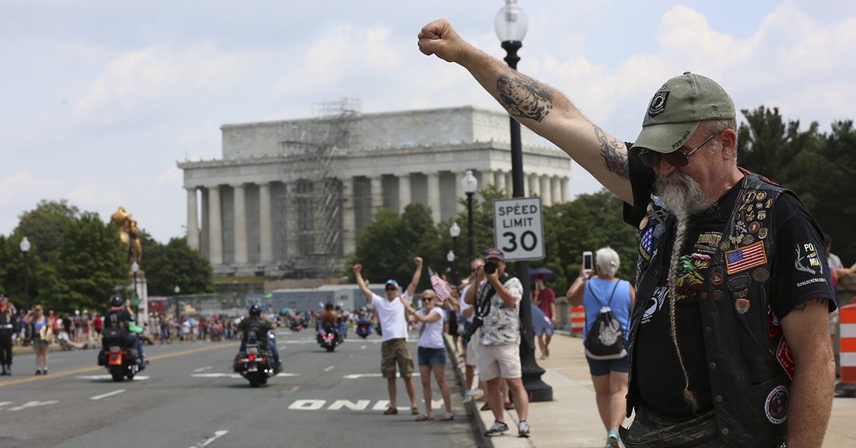 Air Force veteran Ray Weaver from Lancaster, Penn., gives his traditional salute on Sunday, May 27, to riders in the Rolling Thunder motorcycle procession on Memorial Day in Washington, D.C.(Ben Murray/Military Times)