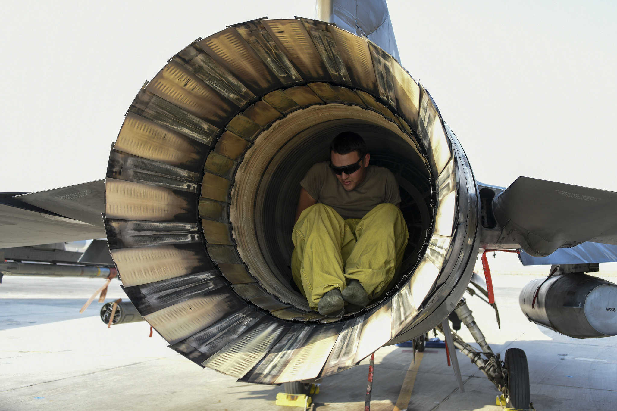 Air Force Staff Sgt. Phillip Easter checks the exhaust of an F-16 Fighting Falcon jet engine at an undisclosed location in Southwest Asia on Sept. 27, 2018. (Master Sgt. Caycee Watson/Air National Guard)