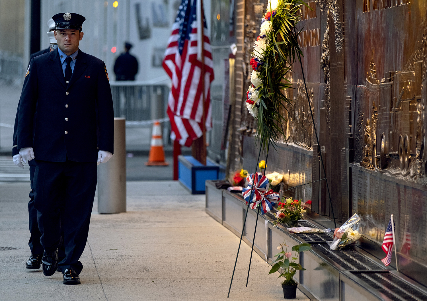 New York City firefighters take a position in front of a memorial on the side of a firehouse adjacent to One World Trade Center and the 9/11 Memorial site during ceremonies commemorating the 18th anniversary of the 9/11 terrorist attacks in New York on Wednesday, Sept. 11, 2019. (Craig Ruttle/AP)