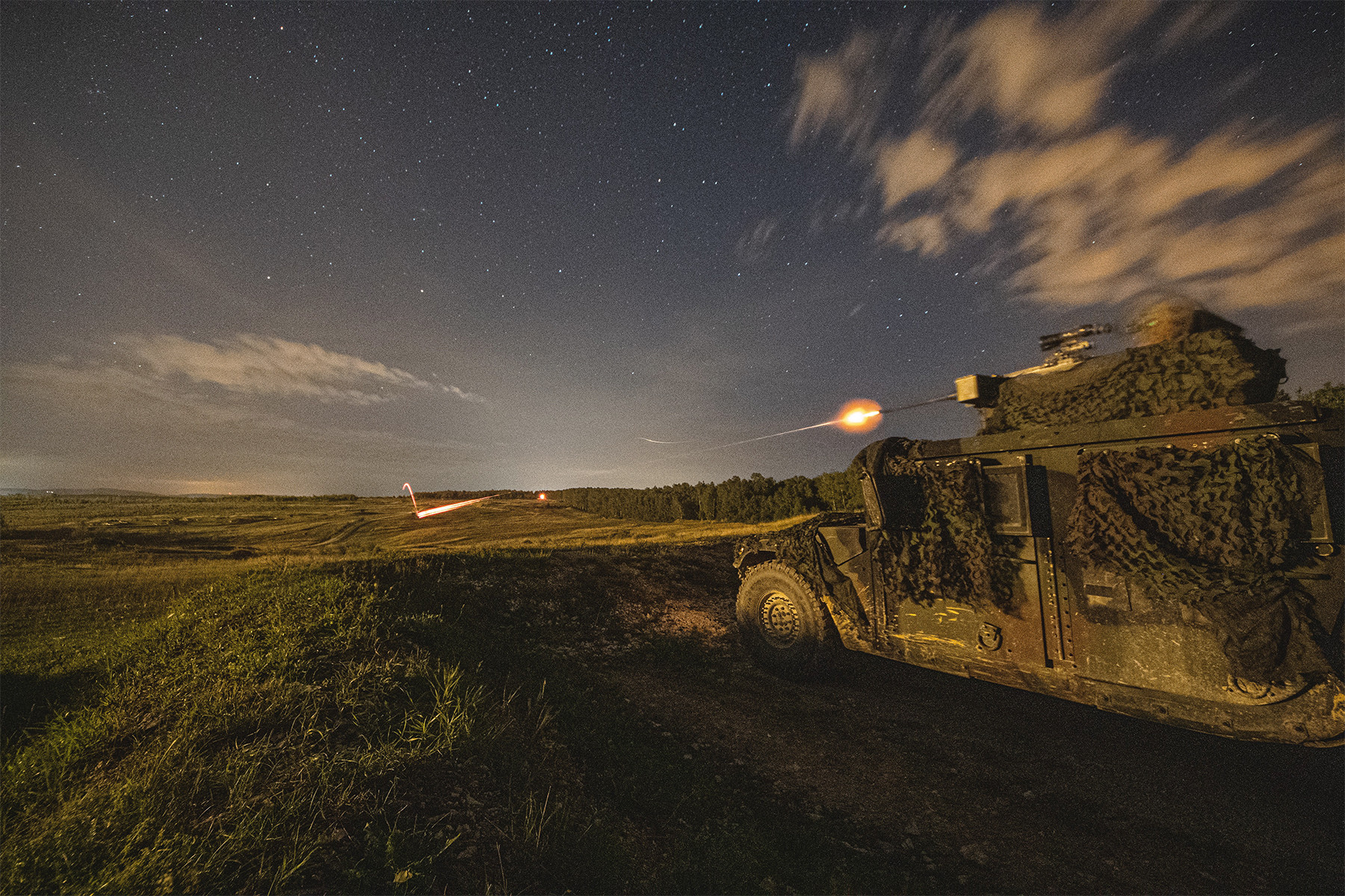 A soldier fires a .50-caliber machine gun during a live-fire exercise at Grafenwoehr Training Area in Germany, Aug. 21, 2019. (Sgt. Henry Villarama/Army)