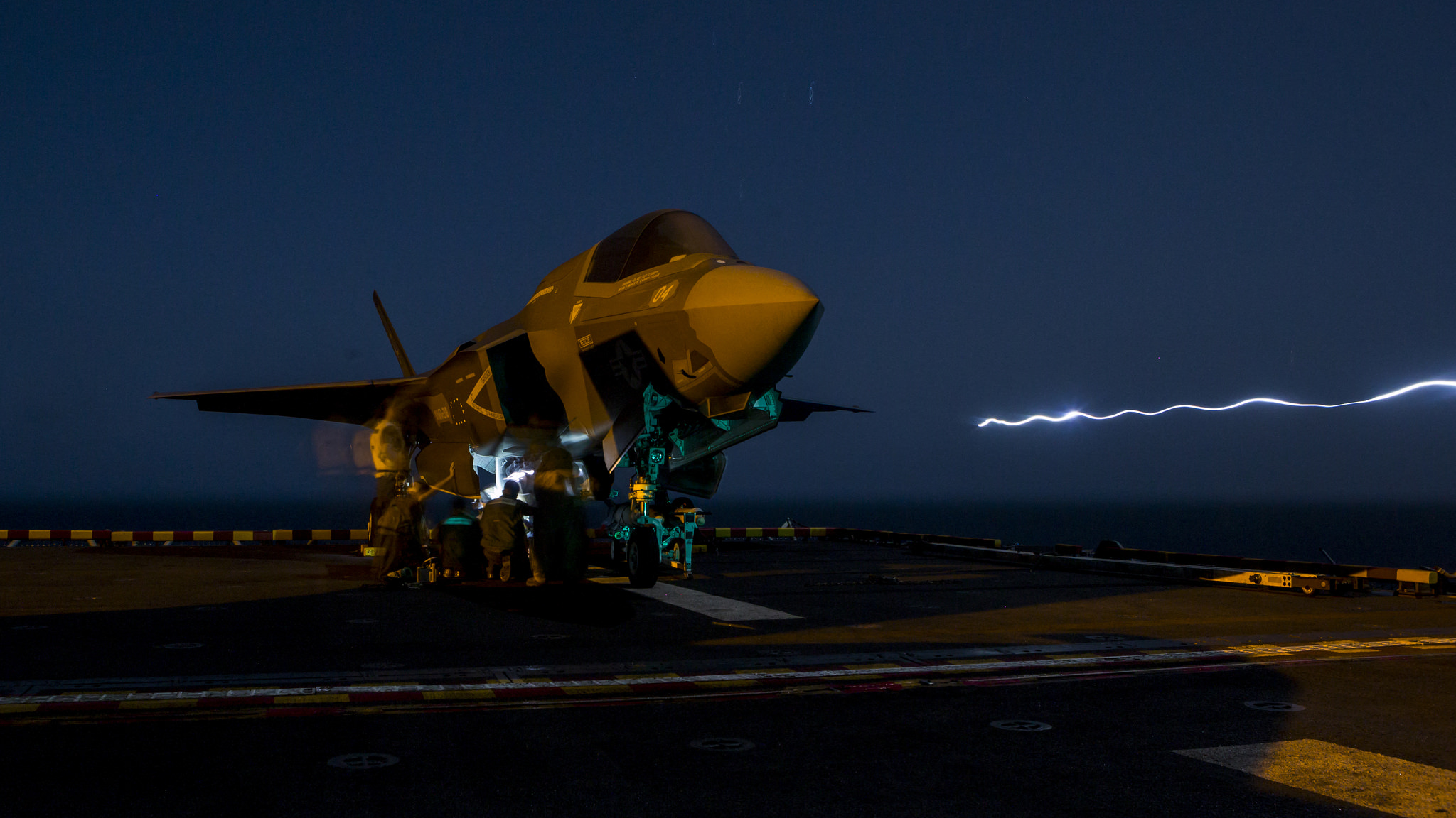 U.S. Marines with Marine Fighter Attack Squadron 211, 13th Marine Expeditionary Unit (MEU), load ordnance into an F-35B Lightning II aboard the Wasp-class amphibious assault ship USS Essex (LHD 2) on Sept. 27, 2018, in preparation for the F-35B's first combat strike. (Cpl. A. J. Van Fredenberg/Marine Corps)