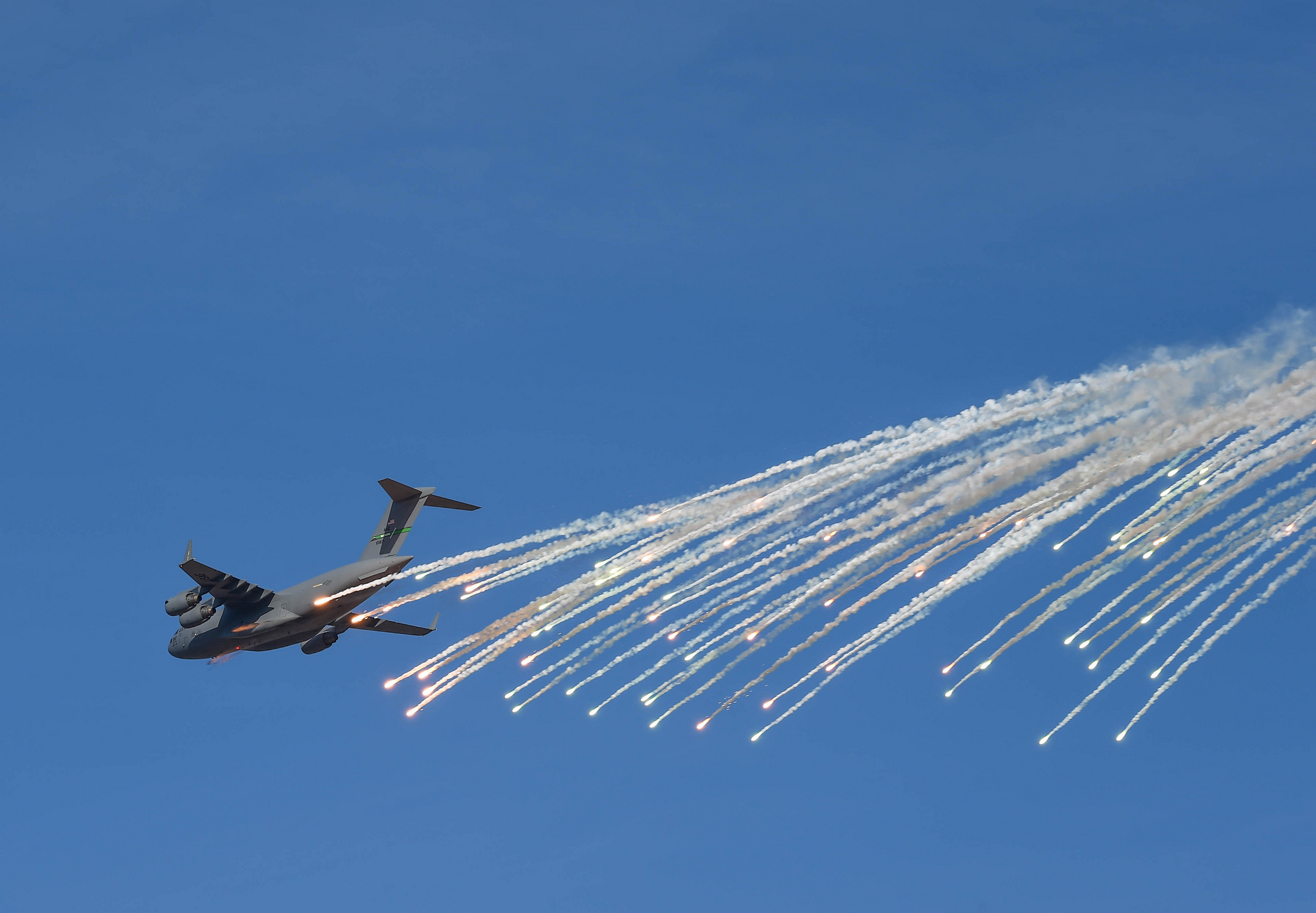 A C-17 Globemaster III, from Joint Base Lewis-McChord, Wash., releases flares above the Selah Airstrip over Yakima Training Center, Nov. 15, 2018. (Senior Airman Tryphena Mayhugh/Air Force)