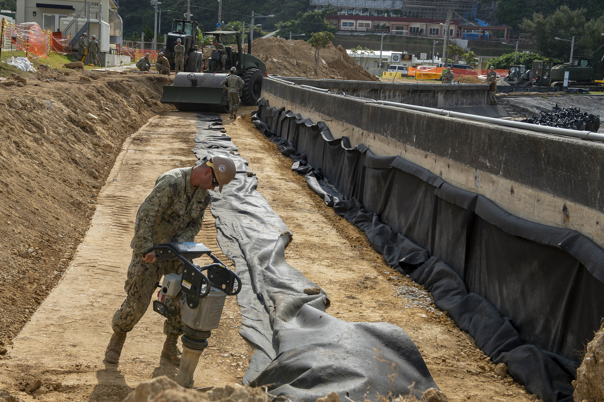 Equipment Operator 2nd Class Aragon Luis operates a compactor at the seawall project at White Beach Naval Facility on Feb. 8, 2020, in Okinawa, Japan. (Mass Communication Specialist 1st Class Stephane Belcher/Navy)