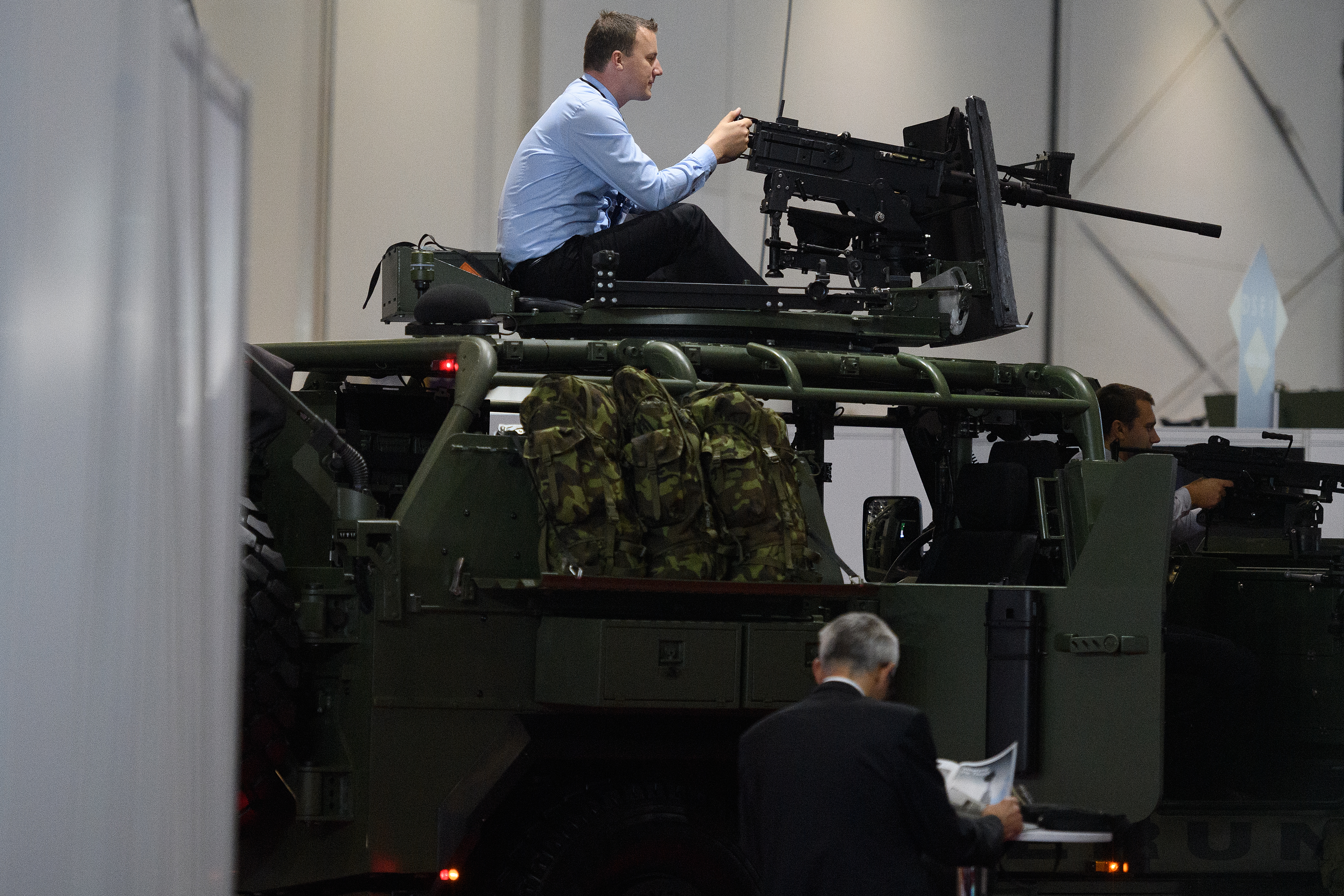 A man tests the gun mounted on an SVOS Perun armored vehicle on Sept. 11, 2019, at DSEI. (Leon Neal/Getty Images)