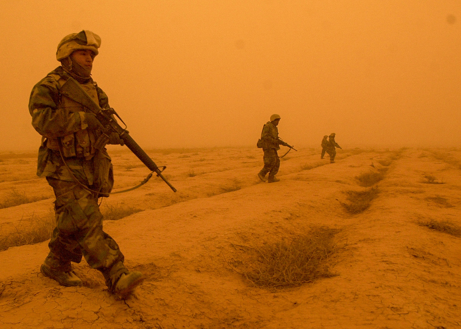 Lance Cpl. Alfredo Martinez, 21, from Lindsay, CA with battery M, 3rd Battalion, 11th Marine Regiment with fellow Marines patrol outside the artillery position in central Iraq to make sure it is safe for the artillery convey to head to another area on March 26, 2003. (Jud McCrehin/Marine Corps Times)