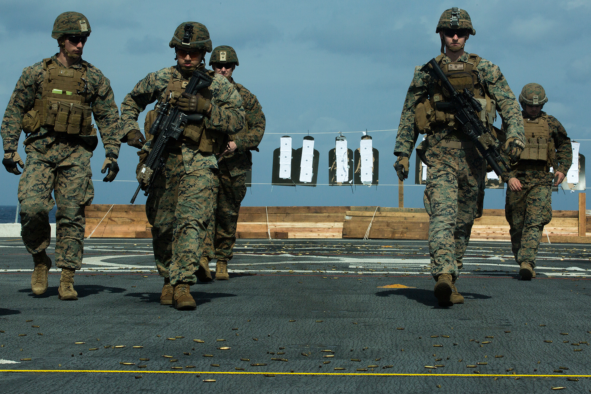 Marines walk back to the firing line during marksmanship training atop the flight deck of the amphibious transport dock USS Green Bay (LPD 20), in the East China Sea, Feb. 2, 2019. (Lance Cpl. Cameron E. Parks/Marine Corps)