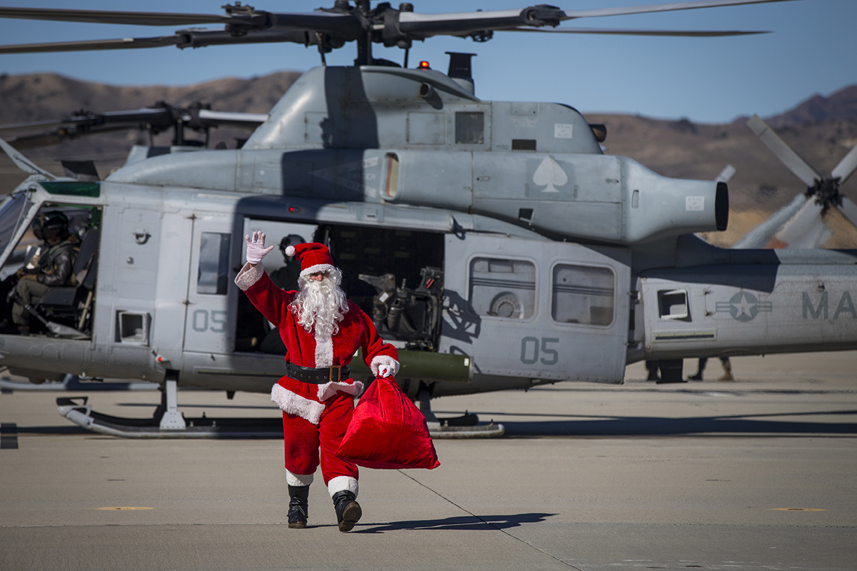 Santa Claus greets U.S. Marines assigned to Marine Light Attack Helicopter Squadron (HMLA) 469, Marine Aircraft Group 39, 3rd Marine Aircraft Wing, and their families during the HMLA-469 annual holiday party at Marine Corps Air Station Camp Pendleton, Calif., Dec. 8, 2018. (Cpl. Juan Bustos/Marine Corps)