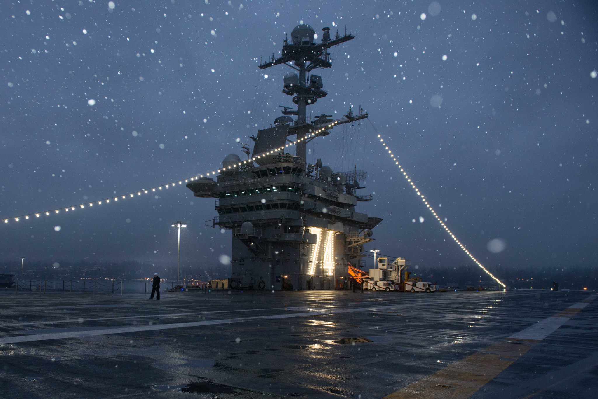 A Sailor walks across the flight deck of the aircraft carrier USS John C. Stennis (CVN 74) after being relieved from watch. John C. Stennis is in port conducting routine training as it continues preparing for its next scheduled deployment. (Mass Communication Specialist Seaman Erika Kugler/Navy)